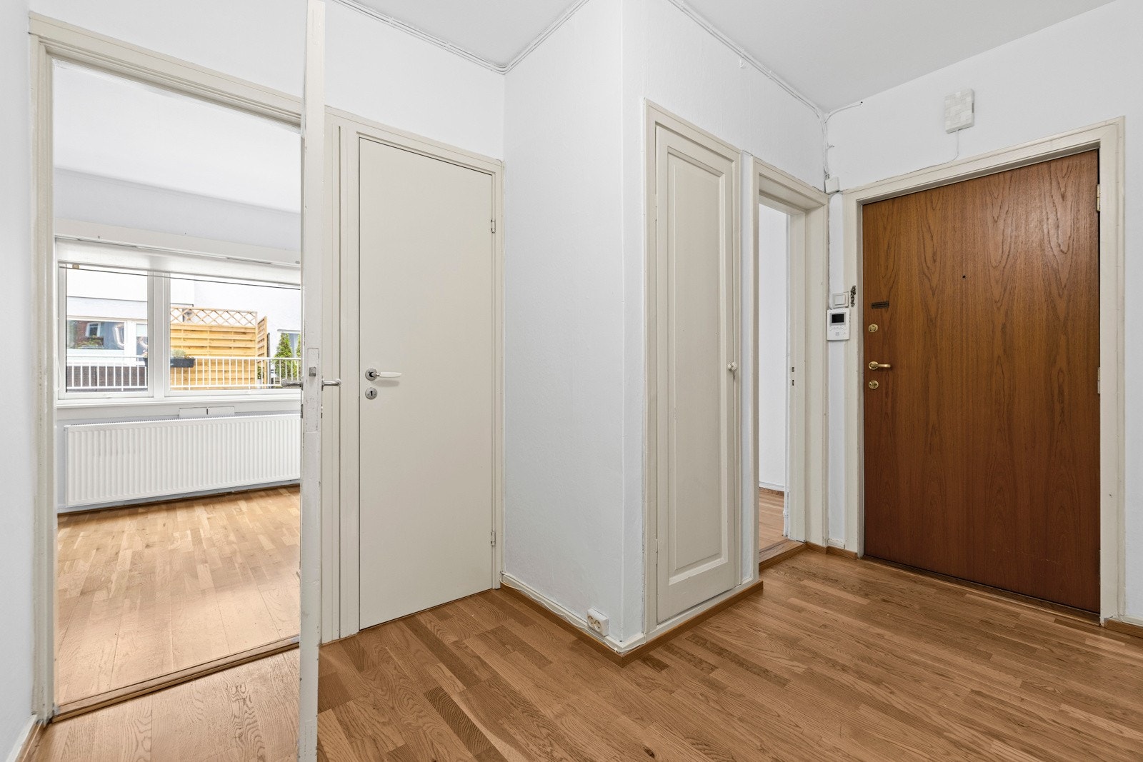 Inngangspartiet har parkett på gulv og malte vegger, som gir et godt førsteinntrykk av leiligheten. I tilknytning entréen er det en praktisk oppbevaring for yttertøy og sko. Galleribilde