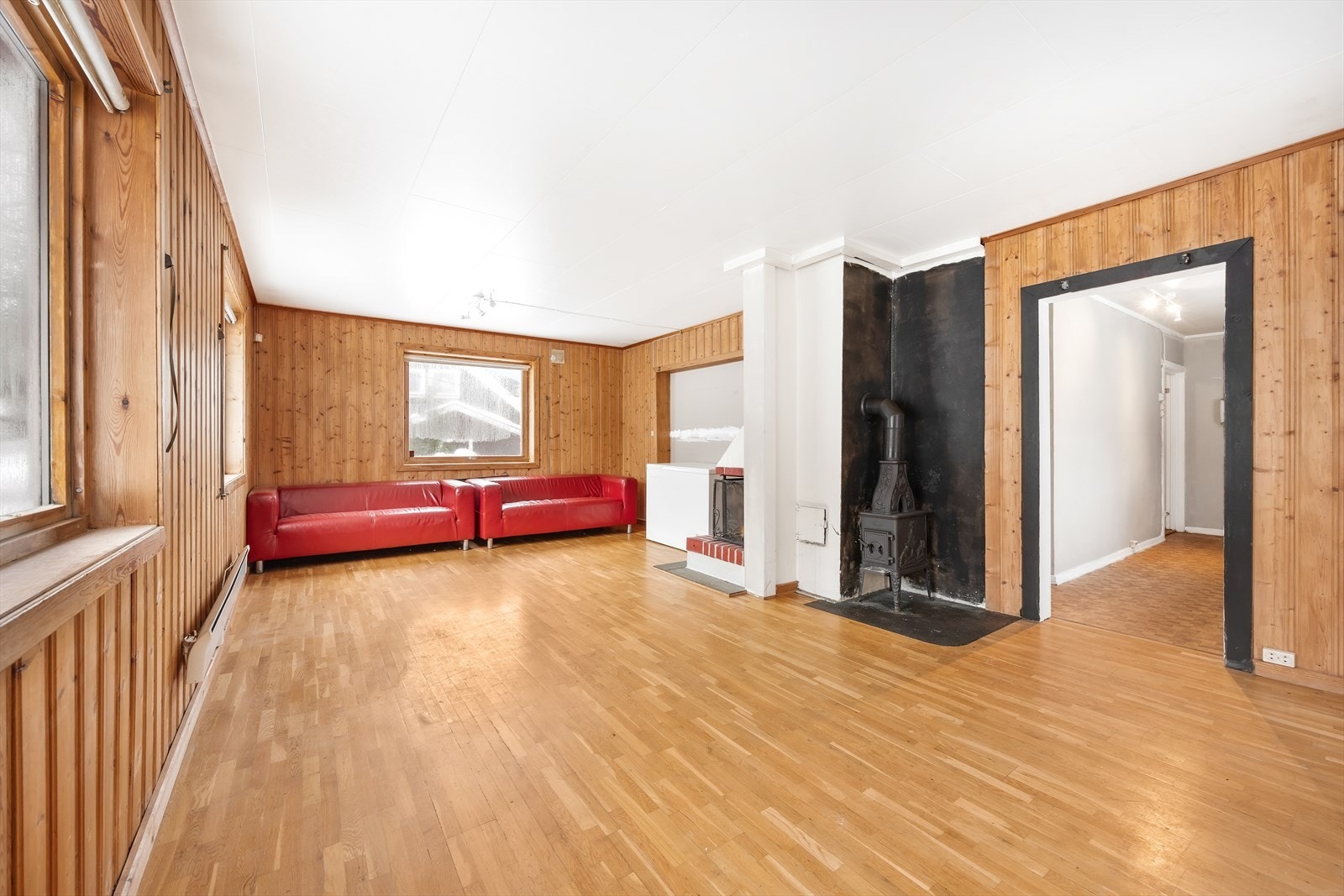 Stue med peis og store vinduer som gir mye lys. Galleribilde
