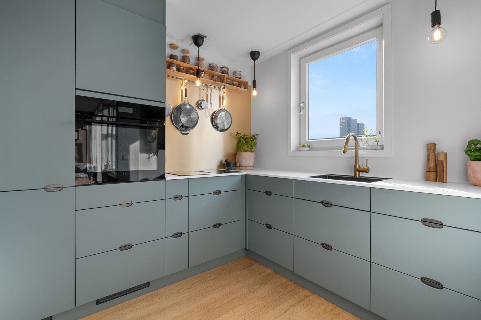 Moderne kjøkken fra 2022 med delvis åpen løsning mot stuen. Innredningen har glatte fronter og benkeplate av kompositt. Galleribilde