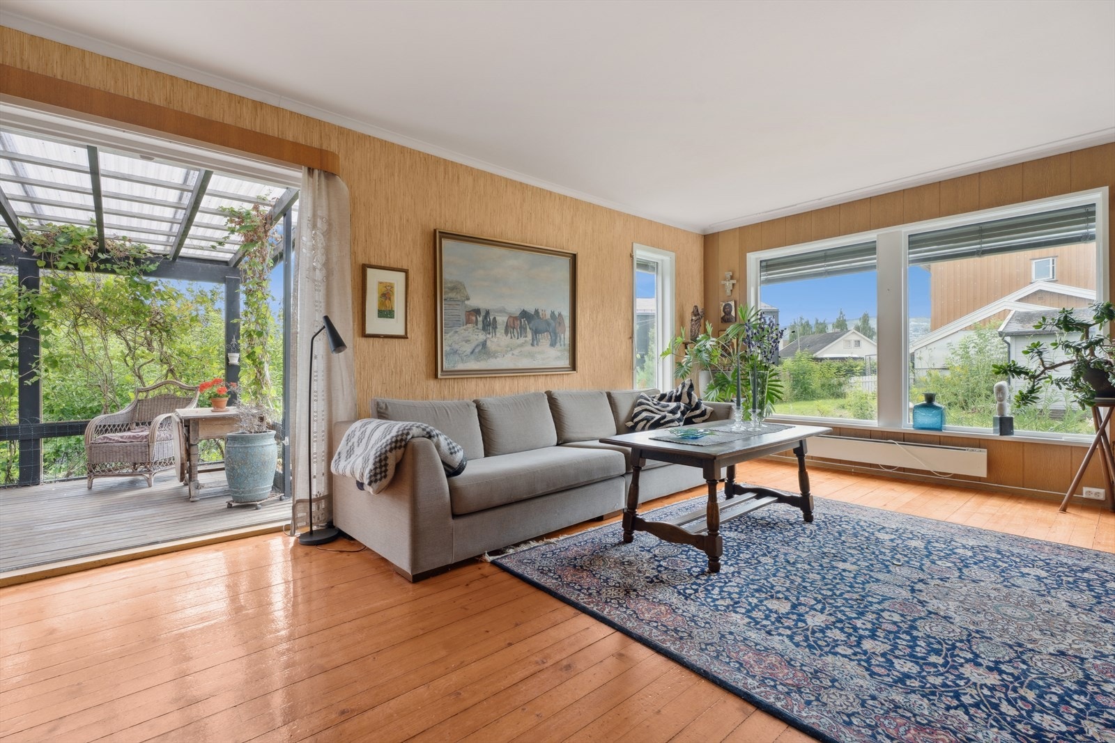 En forlengelse av stuen via tilknyttet terrasse med overbygd tak. Perfekt for utemiddager og direkte tilgang til hage. Galleribilde