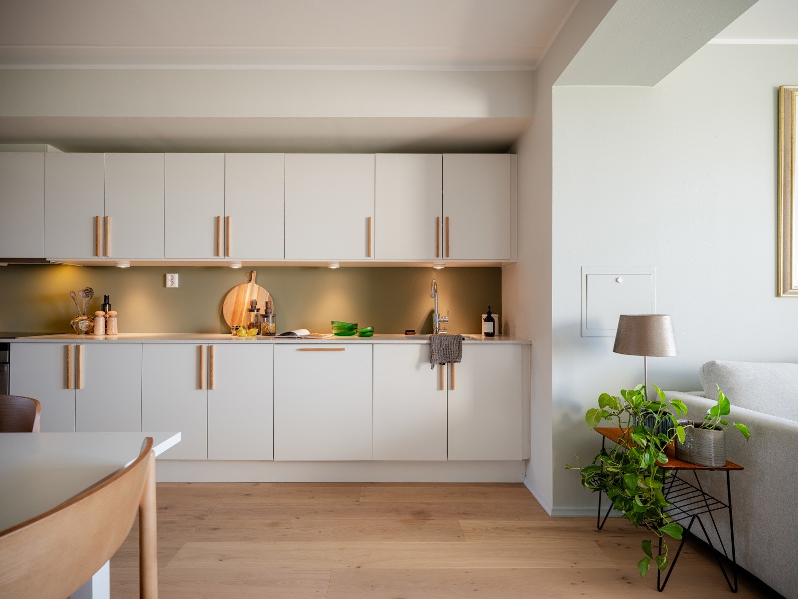 Innredningen har lyse fronter, benkeplate av steinmateriale, underlimt oppvaskkum av rustfritt stål samt benkeskapsbelysning og stikkontakt under overskap. Galleribilde