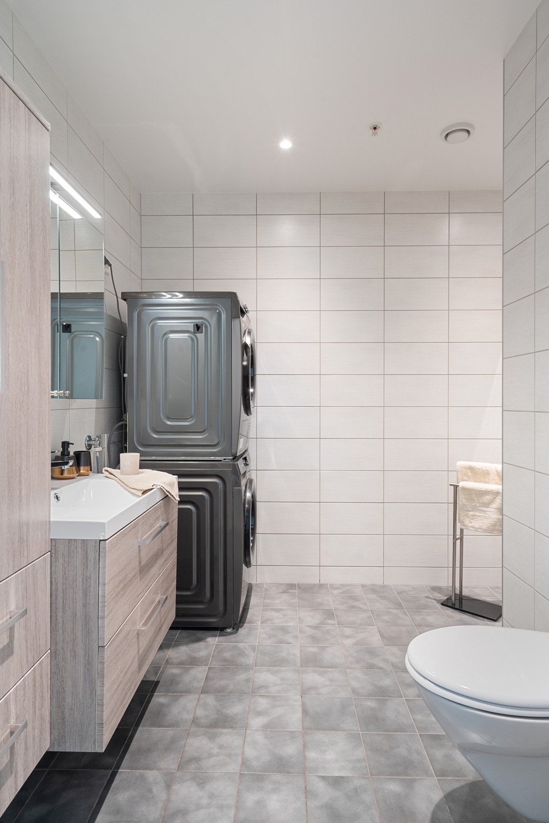 Badet har innredning med nedfelt servant, veggfestet toalett,
dusjhjørne og opplegg for vaskemaskin. Galleribilde