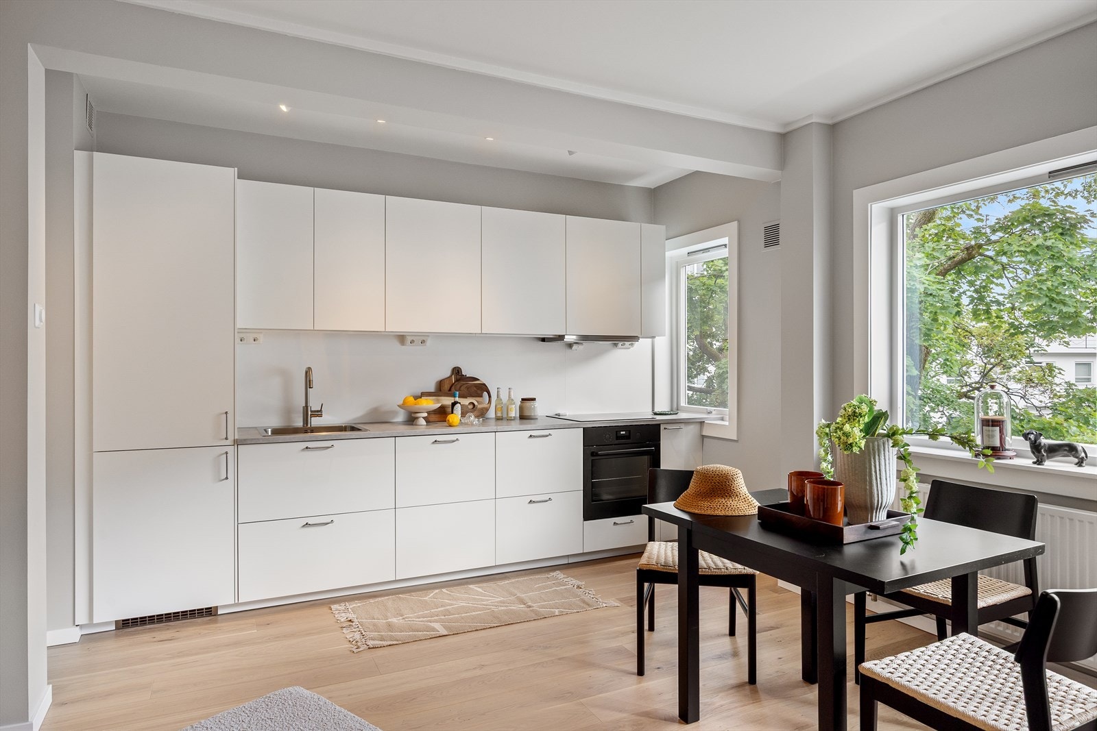 Pent og funksjonelt kjøkken med hvite, laminerte fronter som gir et tidløst uttrykk. Galleribilde