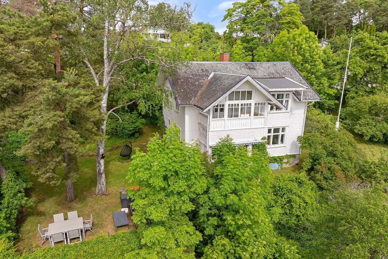 Boligen er beliggende på en tomt med rik vegetasjon Galleribilde