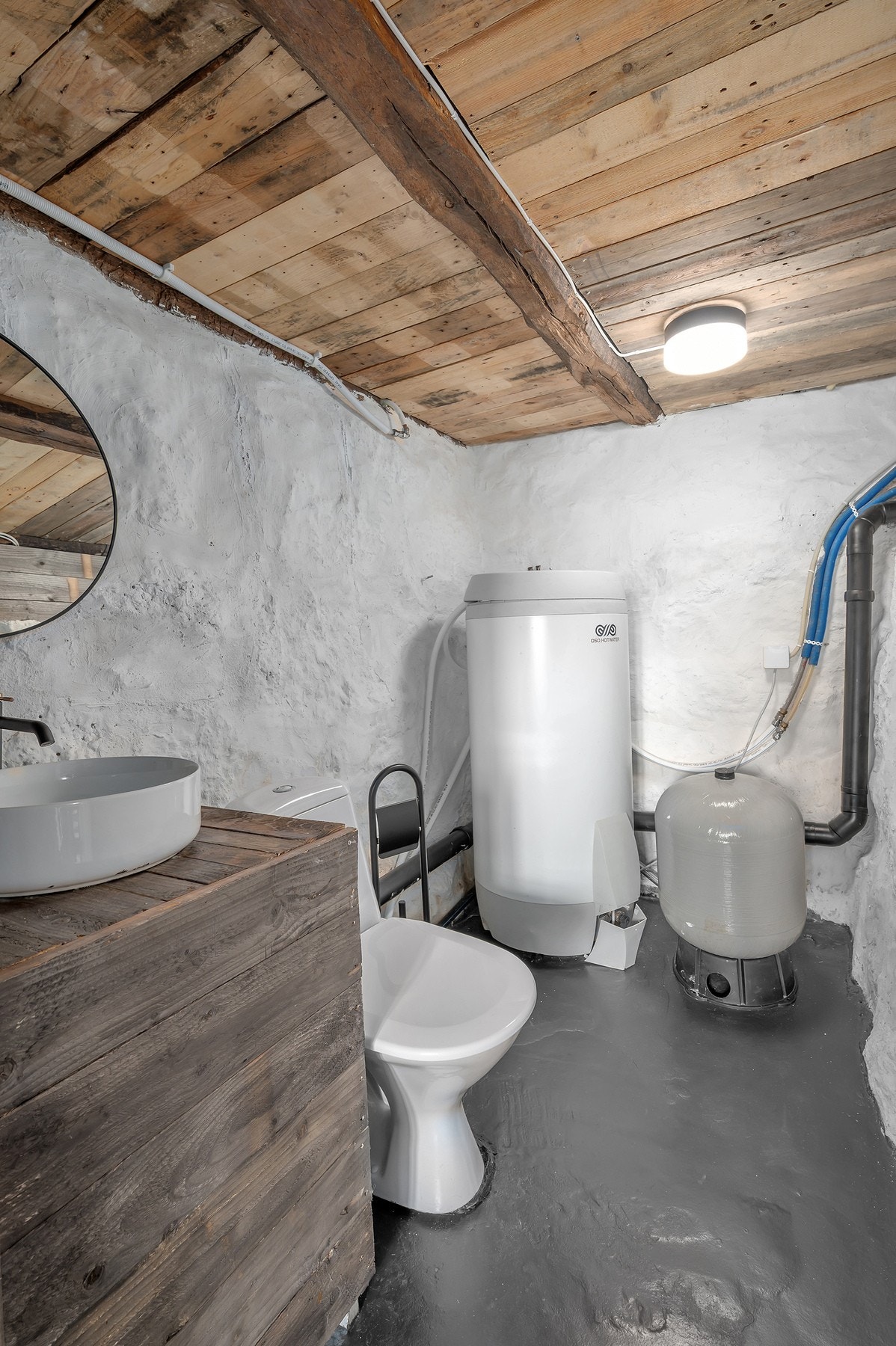 Toalettrom med varmtvannstank og pumpe til vannet. Galleribilde