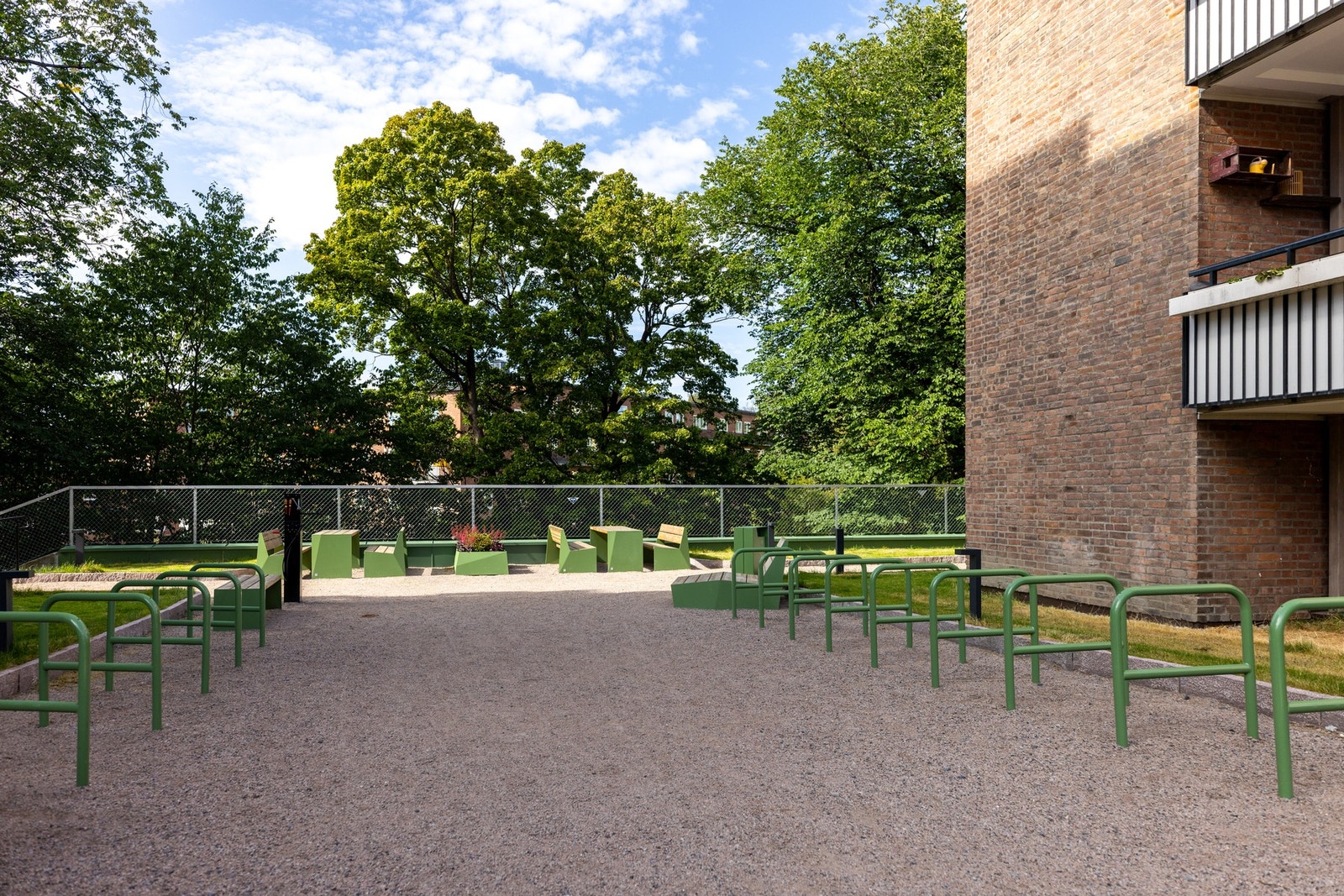 I 2024 ble uteområdet pusset opp med benker, sykkel bod og maleri - her har det blitt forvandlet til en grønn oase. Galleribilde