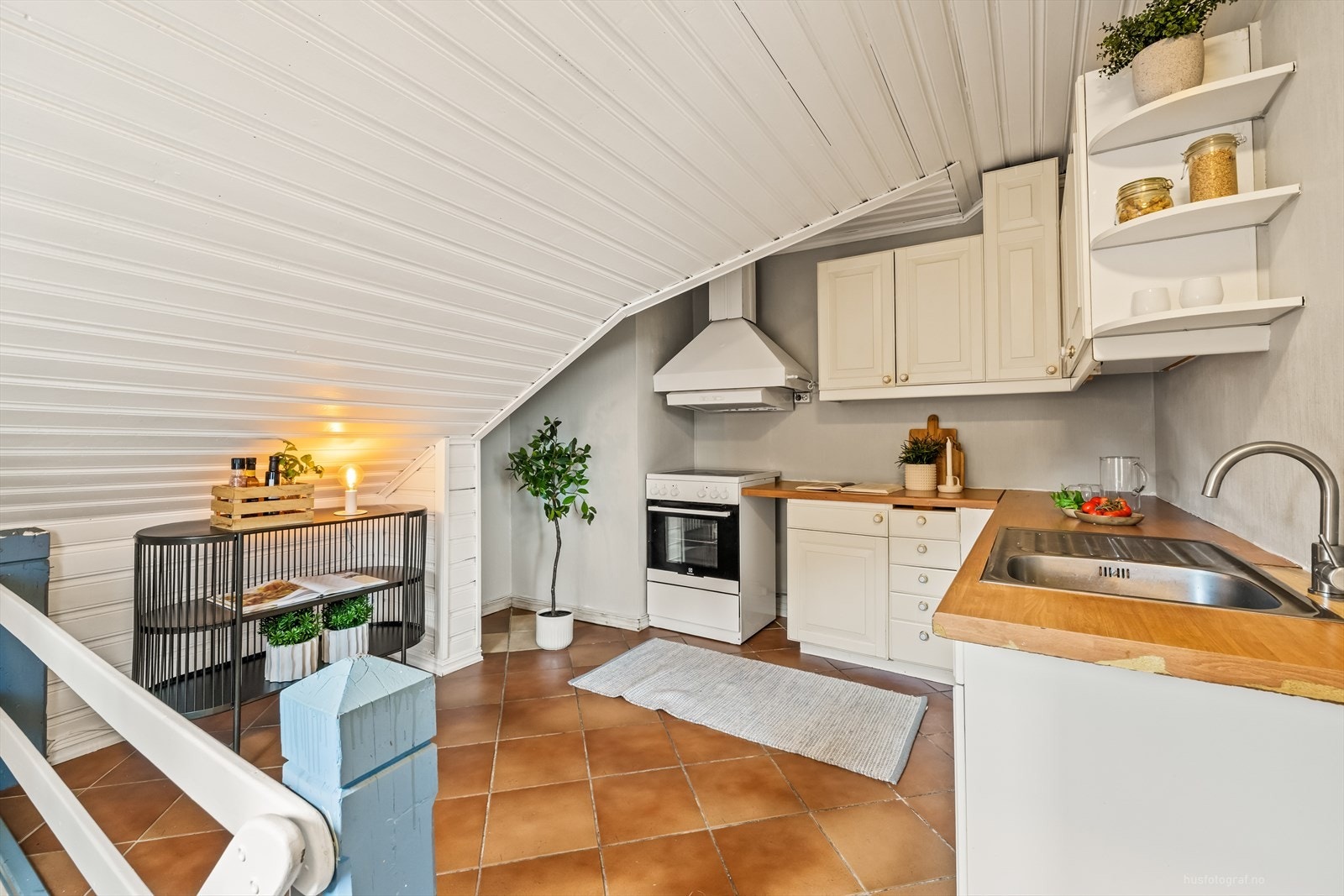 Kjøkken med lys profilert kjøkkeninnredning. Montert avtrekksvifte over komfyr. Spiseplass. Galleribilde