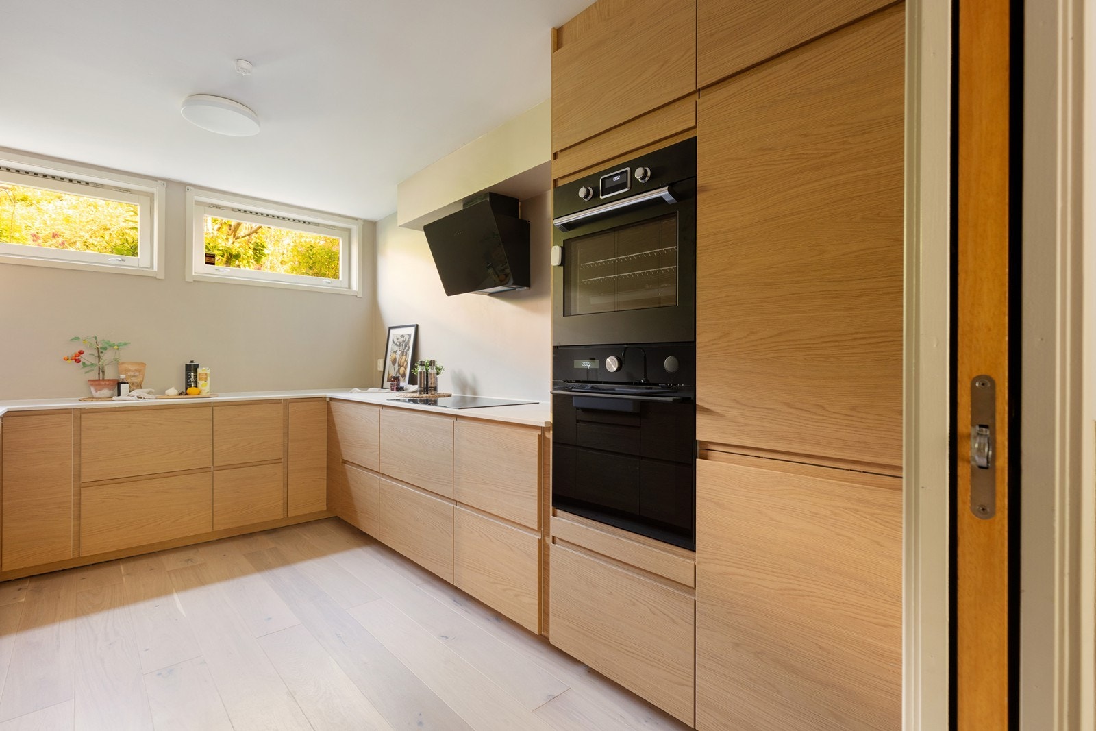 Et lekkert og innbydende kjøkken med integrerte hvitevarer. Galleribilde