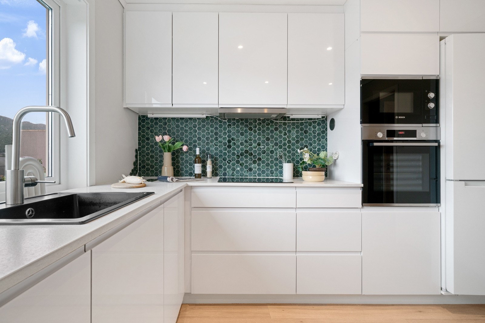 Kjøkkenet har integrerte hvitevarer som platetopp m/ induksjon, stekeovn, oppvaskmaskin og micro Galleribilde