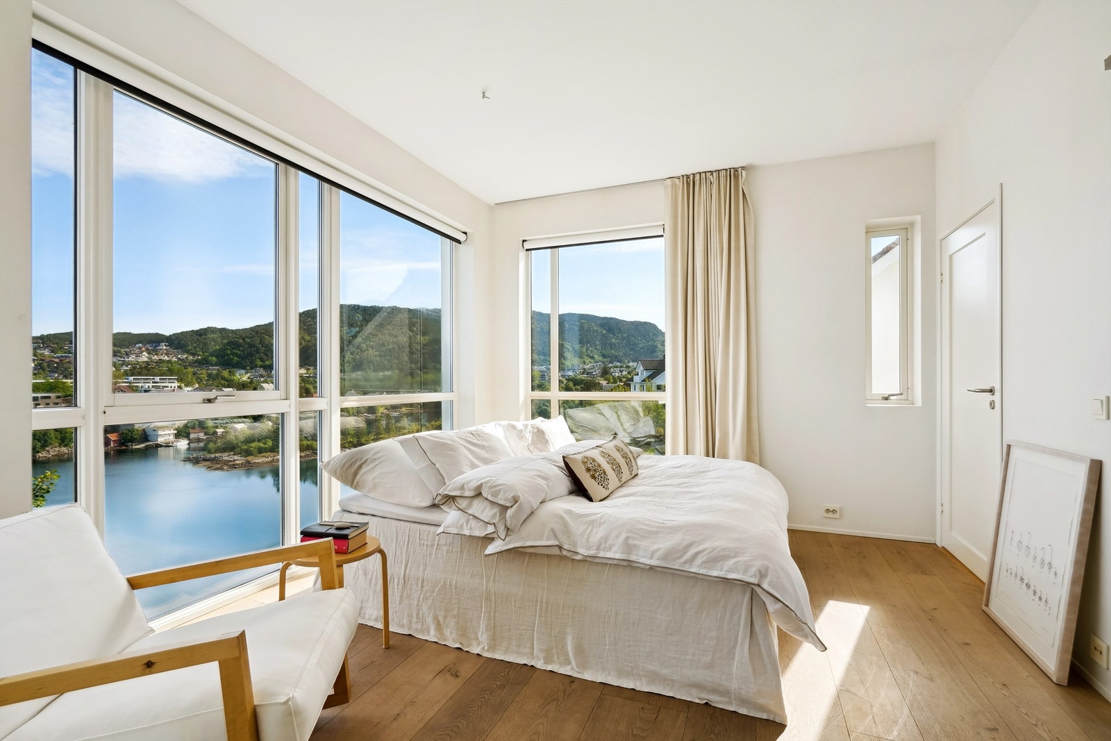 Store vindusflater på hovedsoverommet slipper inn rikelig med dagslys og har flott utsikt mot sjøen og inn i den idylliske bukten Galleribilde