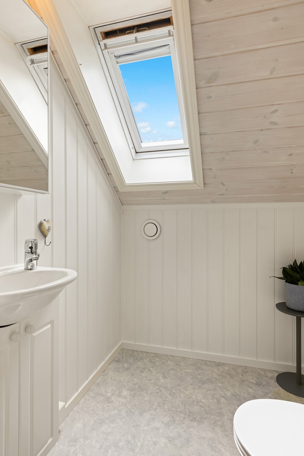 Rommet har belegg på gulvet og malt panel på veggene. Her er det takvindu som gir godt med lys på dagtid. Galleribilde