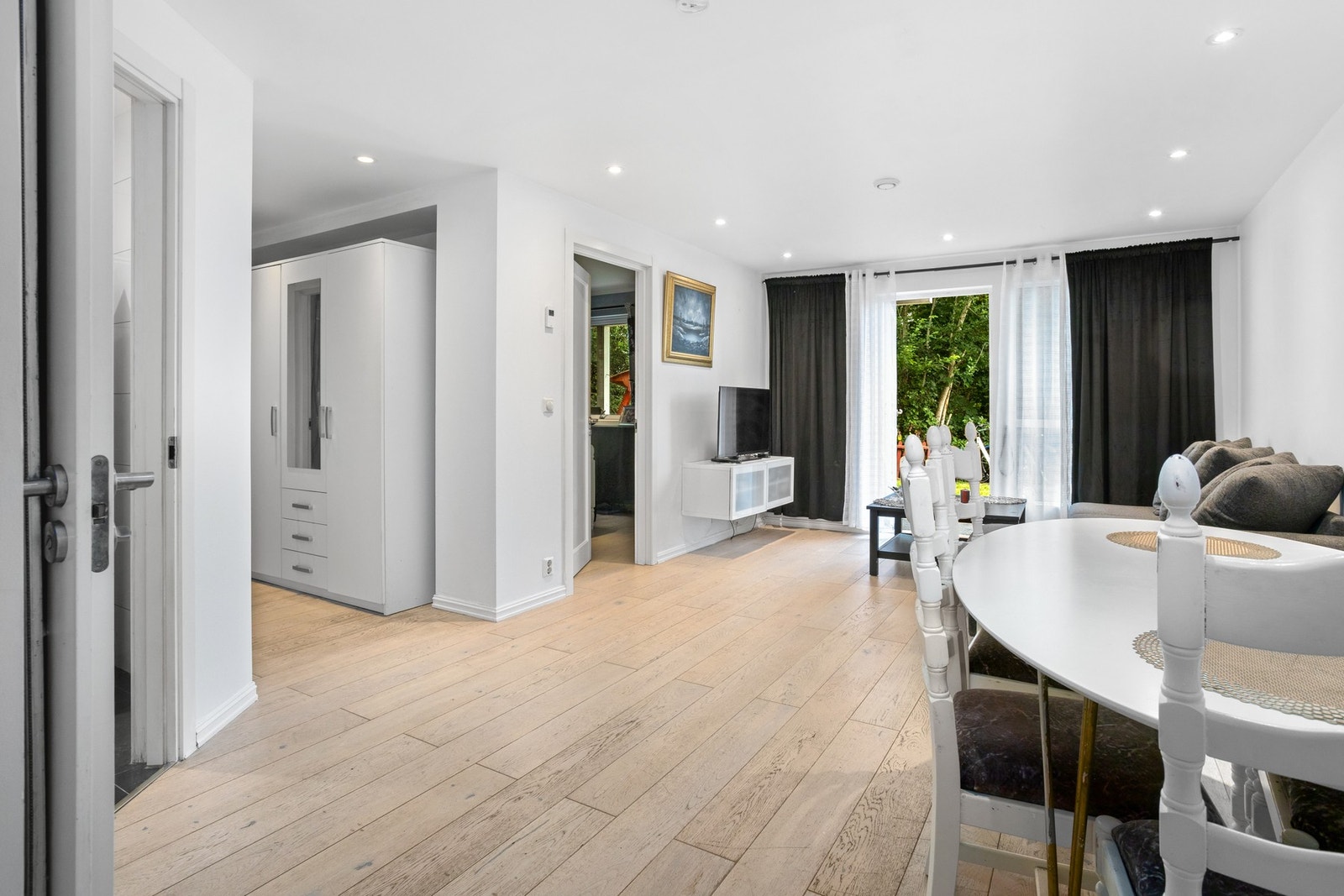 Stuen er lys og romslig med åpen løsning mot kjøkkenet. Galleribilde