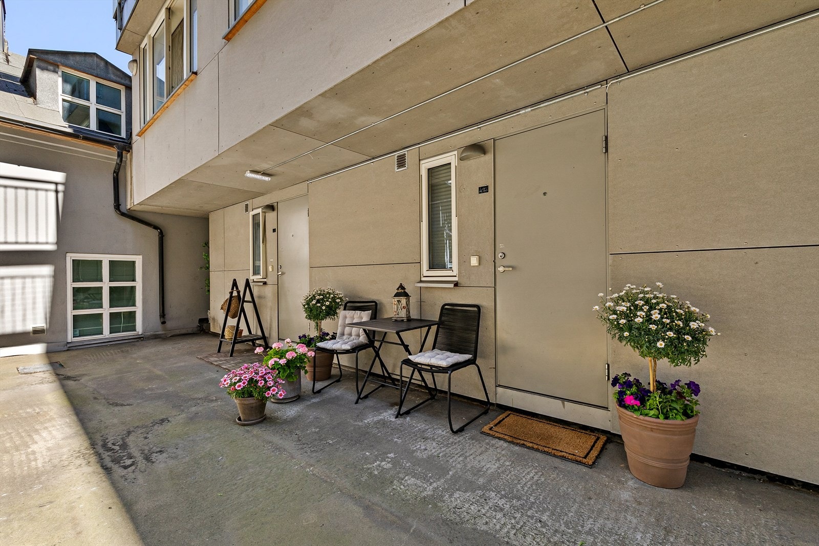 Egen inngang til leiligheten med hyggelig cafe sett i forkant Galleribilde