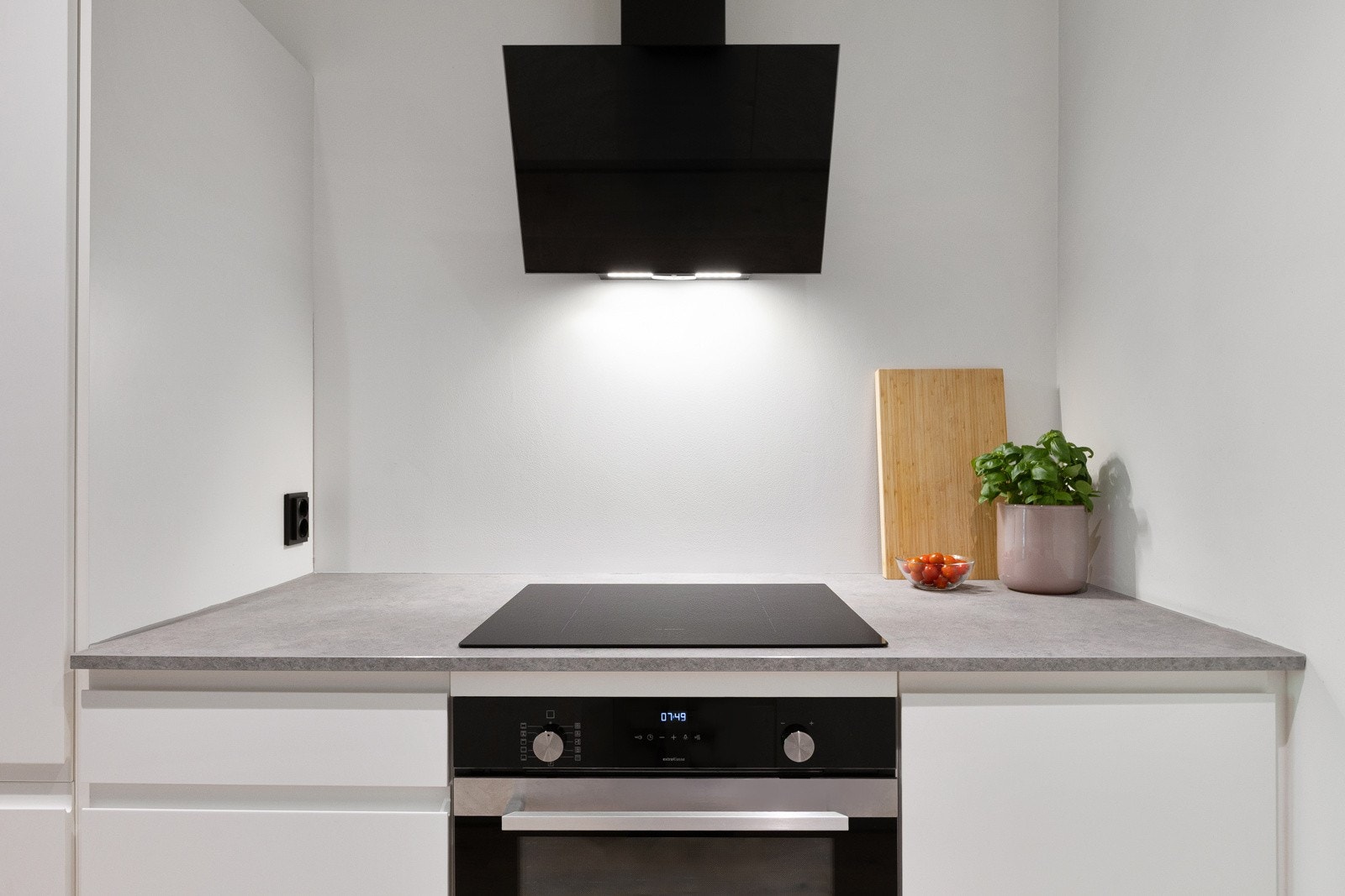 Innredningen inkluderer integrerte hvitevarer som komfyr, induksjonstopp, oppvaskmaskin, kjøleskap og fryseskap Galleribilde