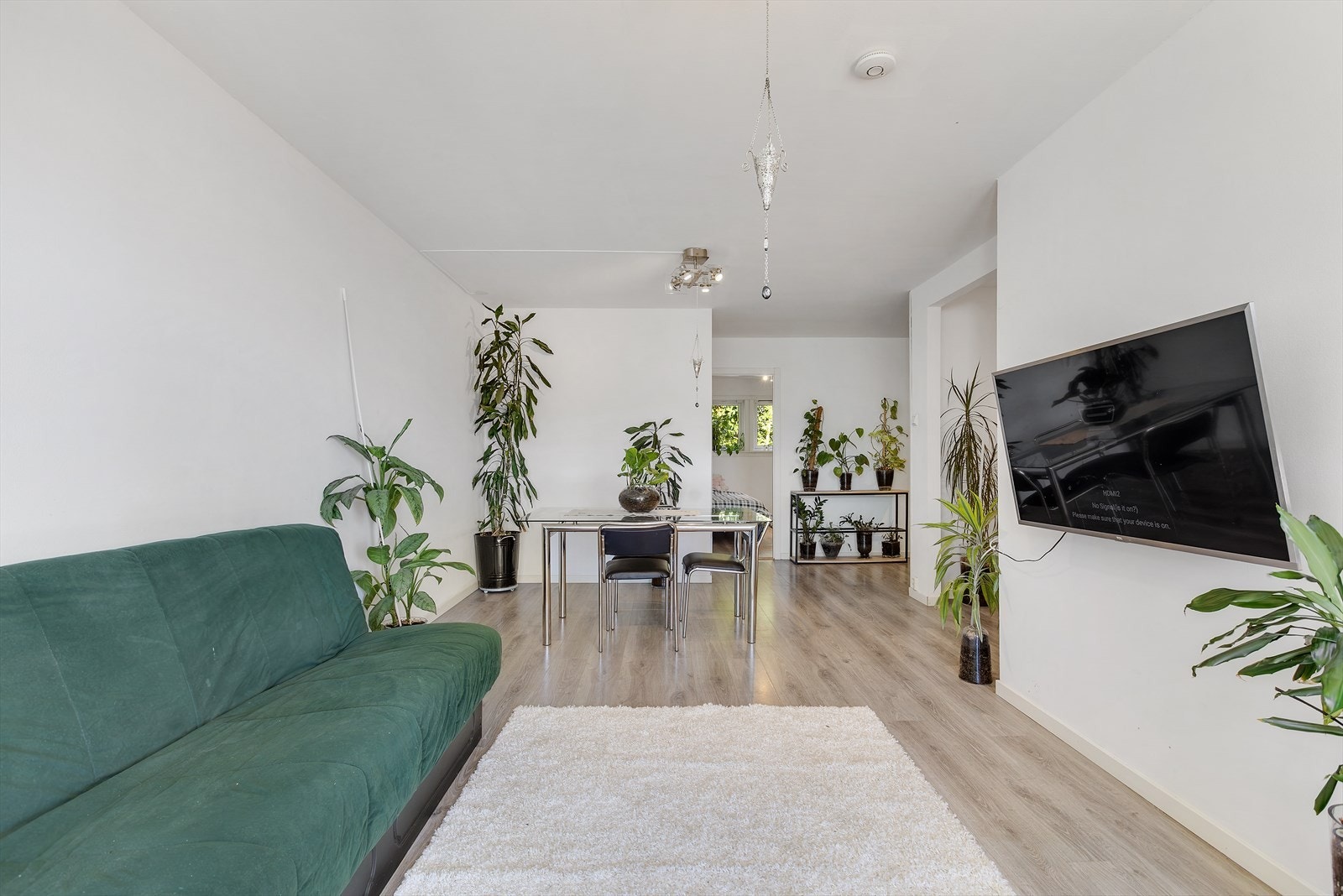 Rommet har en enkel og moderne utforming med lyse, nøytrale vegger og laminat på gulv, som gir en fin base for ulike møbleringsløsninger. Galleribilde
