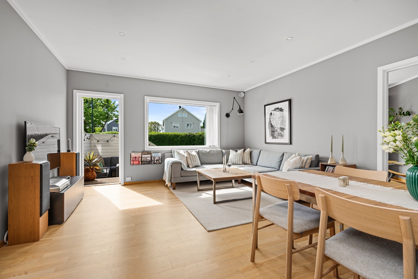 Velkommen inn! Fra uteområdet, via den nye balkongdøren (ny i 2022), kommer du inn i stuen som er moderne, lys og innbydende. Her er det slette overflater på vegger og i himlingen hvor det er lagt opp til downlights. Galleribilde