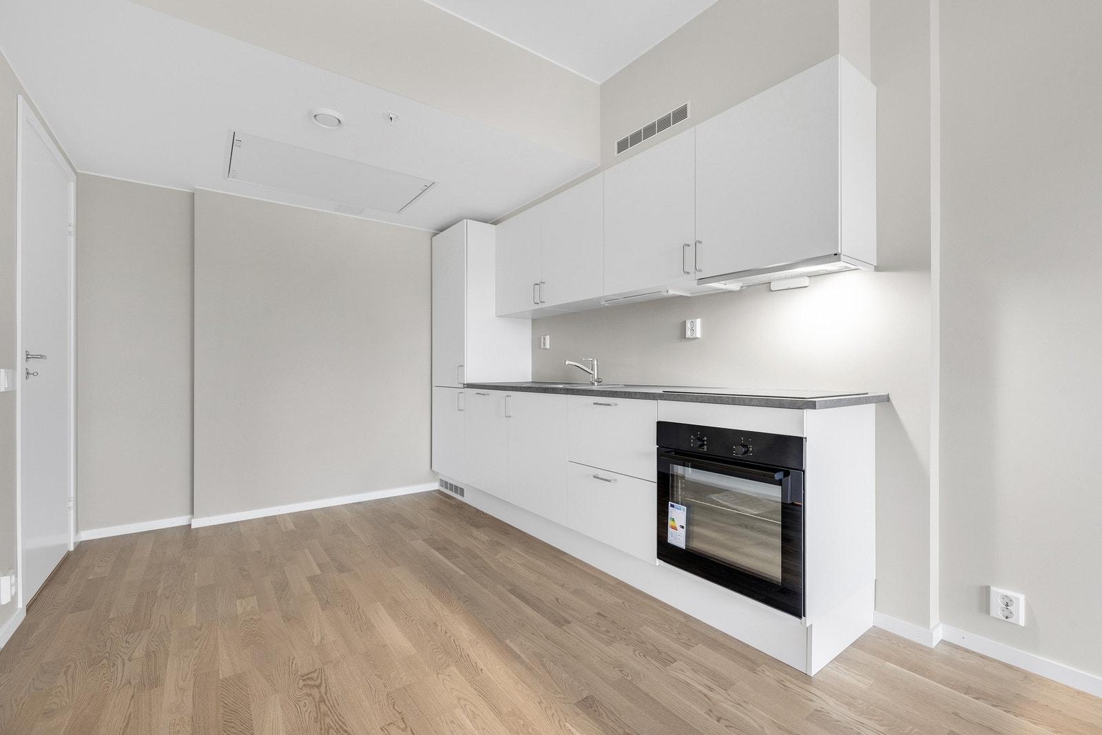 Stilrent og funksjonelt kjøkken med god arbeidsplass og moderne innredning - store vindusflater mot øst gir rikelig med dagslys og en lys, åpen atmosfære. Kjøkkenet ligger i naturlig tilknytning til stue og balkong, og gir en effektiv og sosial planløsnin Galleribilde