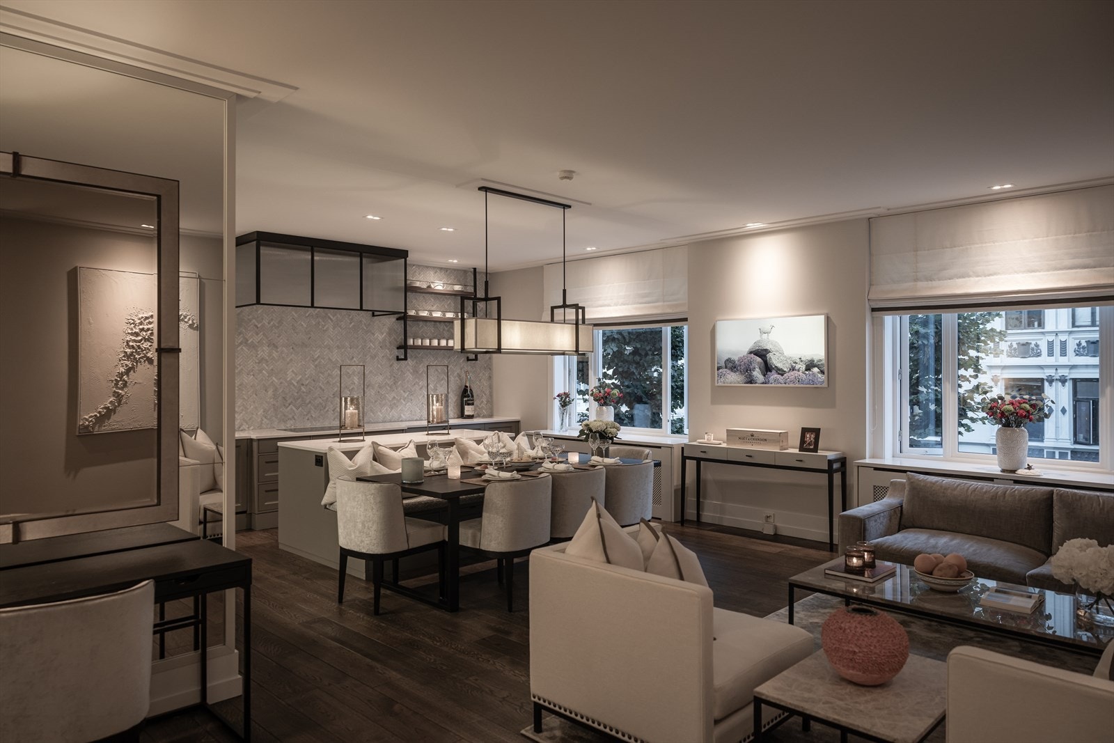 Stort, sosialt oppholdsrom med snekkerbygget kjøkken med øy Galleribilde