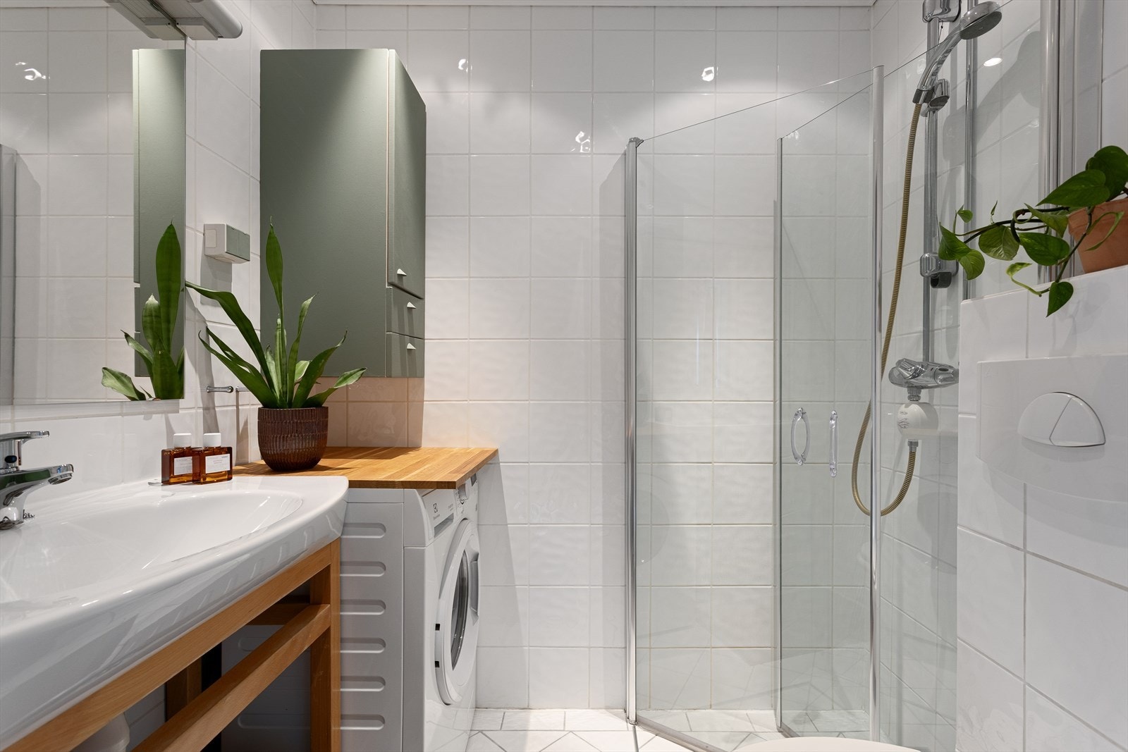 Pent og praktisk bad med gulvvarme og innfelte downlights i himling. Badet er innredet med servantbenk med heldekkende servant og ettgreps blandebatteri, vegghengt toalett, dusjhjørne samt opplegg for vaskemaskin. Galleribilde