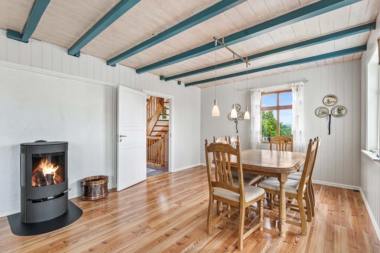 Vedovn i stue. Ildstedet ble oppgradert i 2024 med innvendig keramisk foring i pipe og ny vedovn. Galleribilde