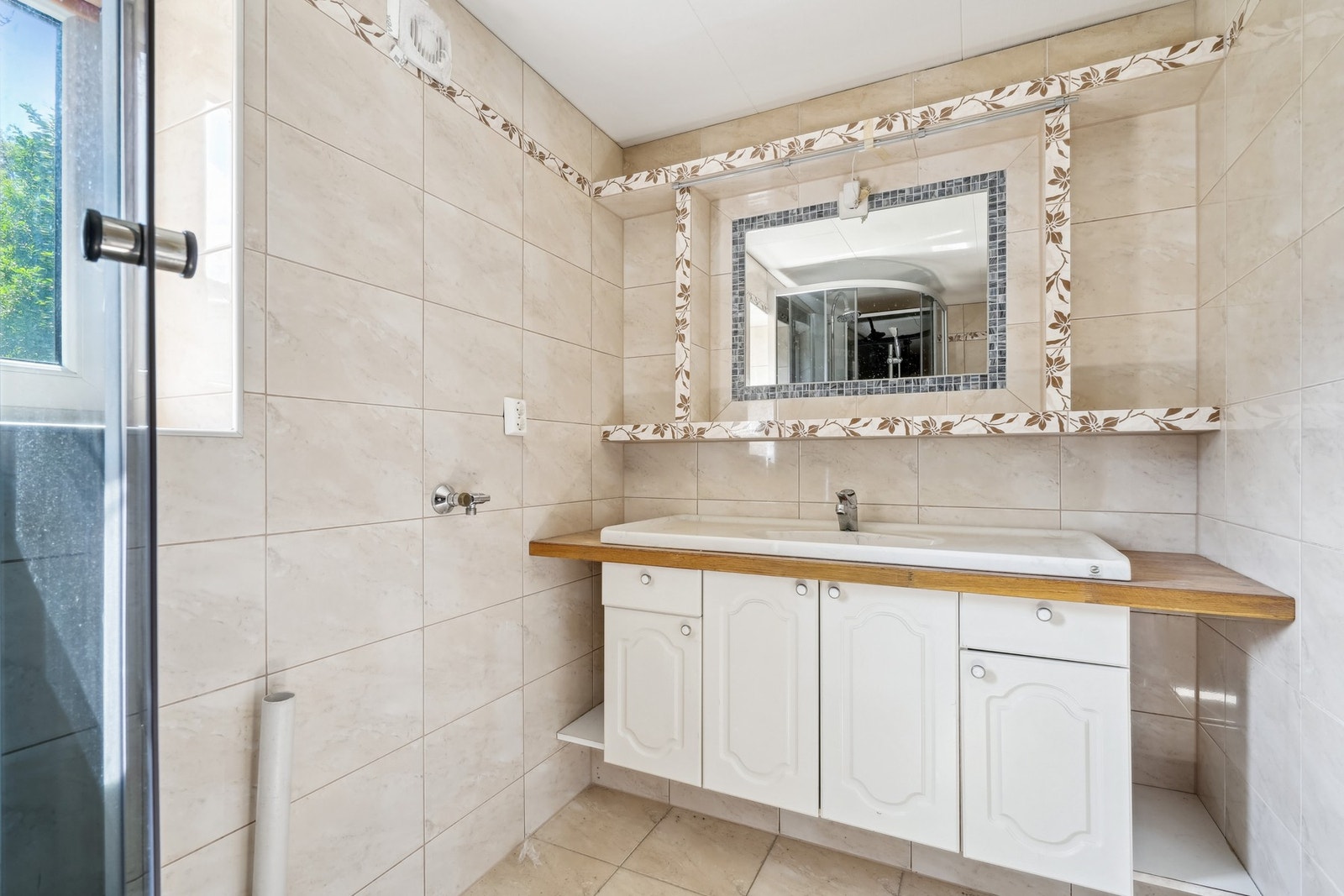 Romslig baderomsmøbel med nedfelt servant, vegghengt toalett og dusjkabinett. Galleribilde