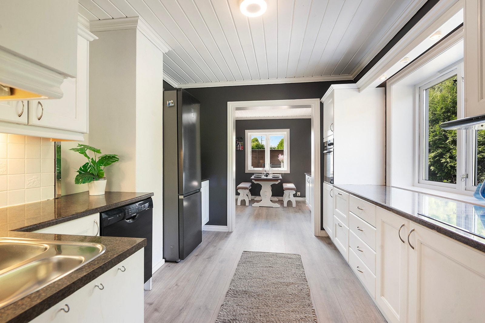 Et lyst og romslig kjøkken med rikelig benke- og skapplass som legger til rette for både matglede og kreativitet Galleribilde