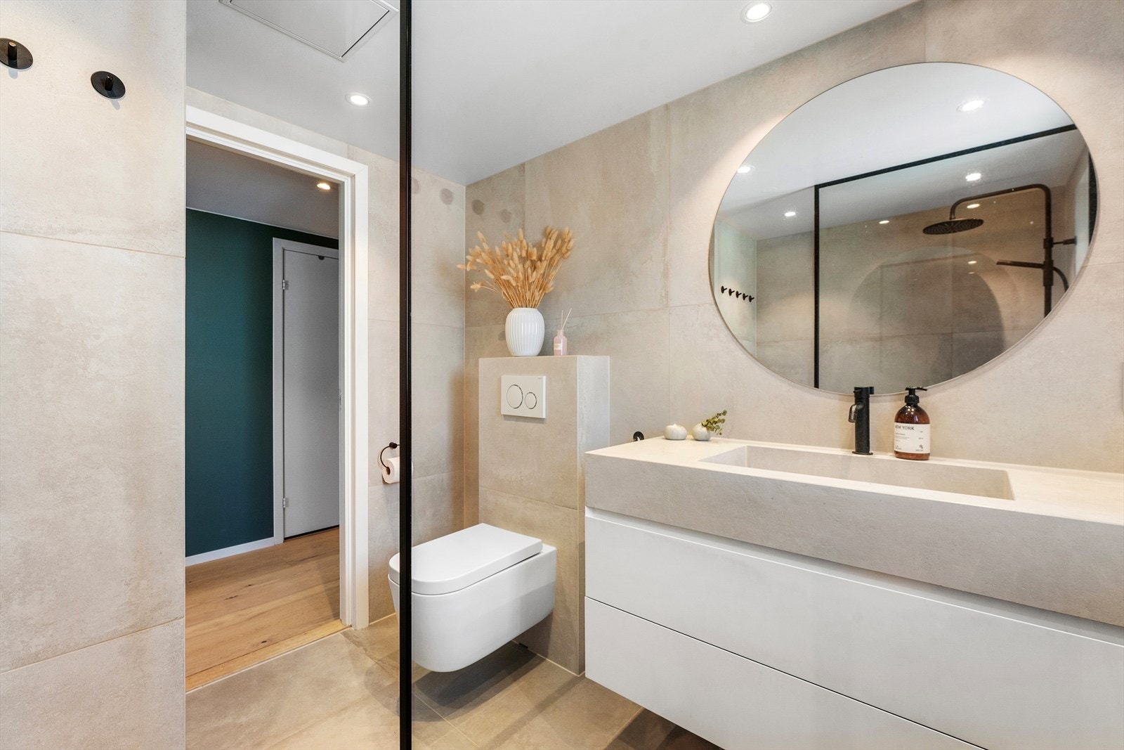 Benkeskap med oppbevaringsplass, speil over servant og veggfestet toalett Galleribilde