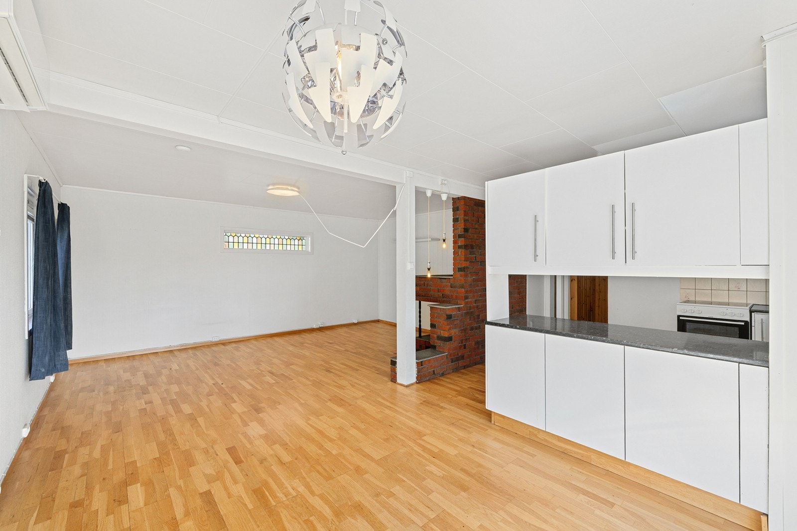 Kjøkkeninnredningen har hvite, glatte fronter og laminert benkeplate. Galleribilde