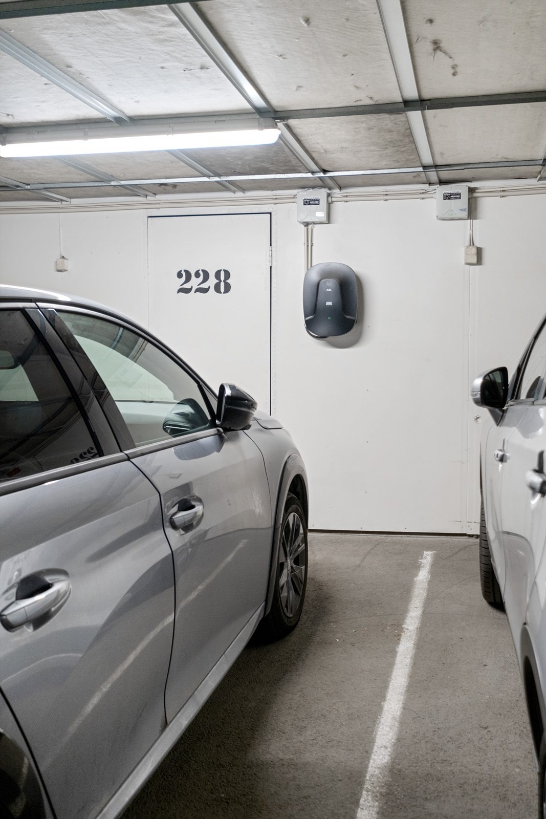 Romslig parkeringsplass i lukket garasjekjeller med egen elbillader inkludert Galleribilde