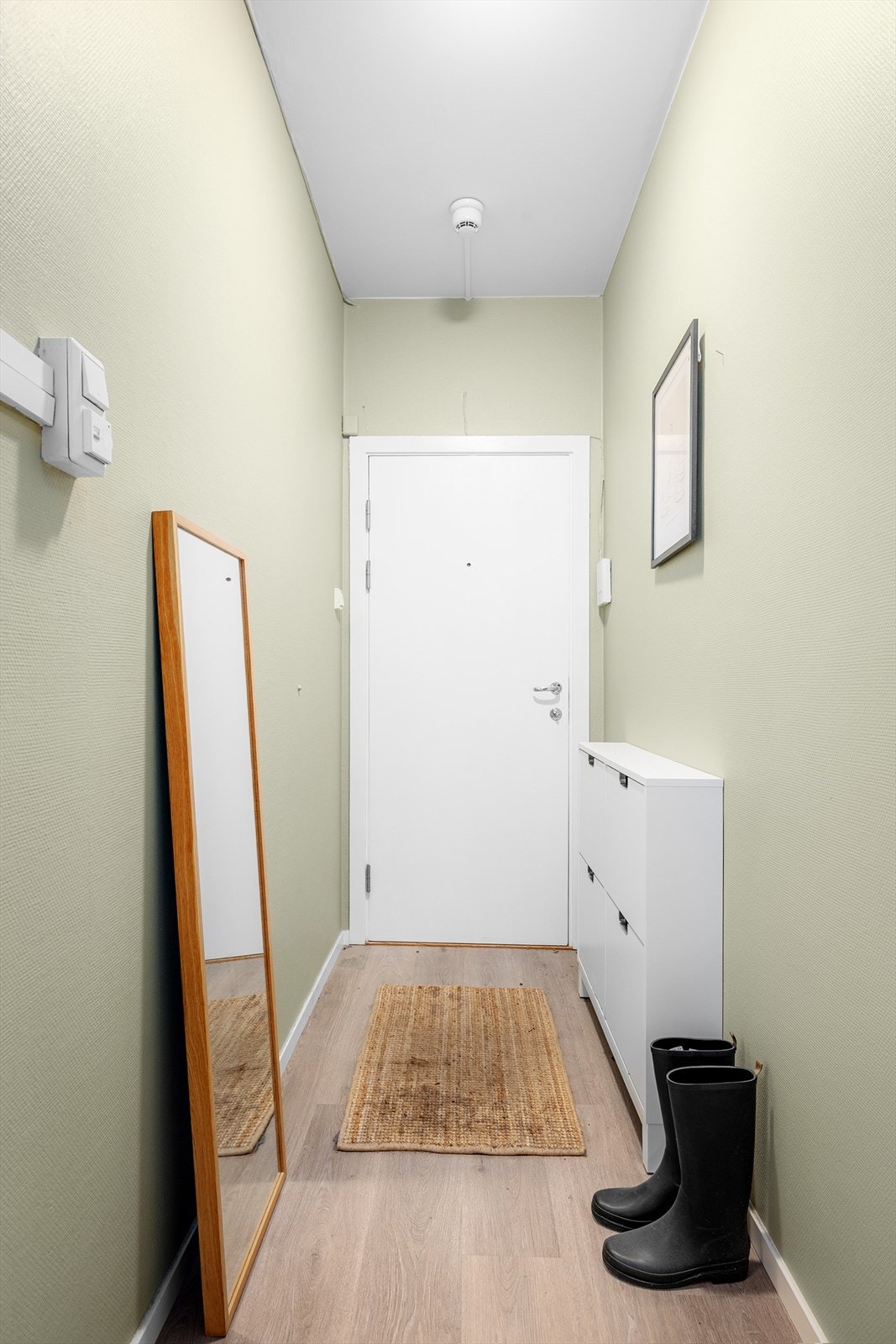 Velkommen inn i en funksjonell og innbydende entré med god plass til både yttertøy og sko. Galleribilde