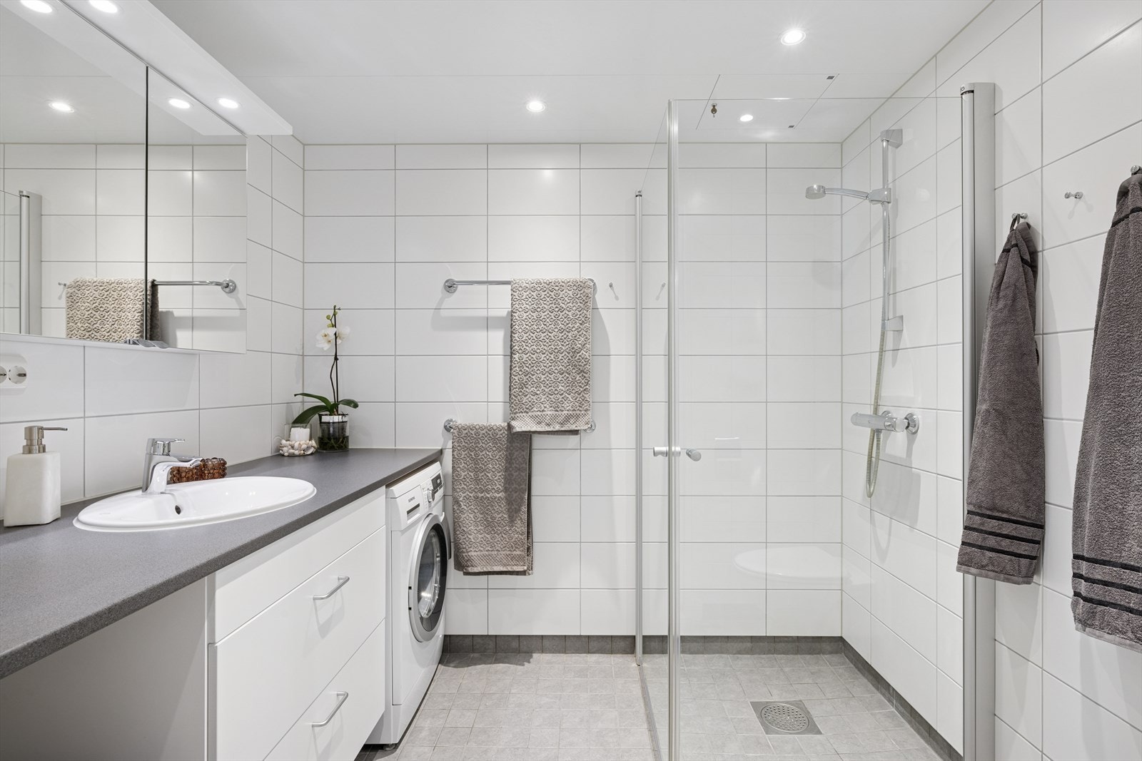 Pent flislagt bad med varmekabler i gulvet og downlights i taket Galleribilde