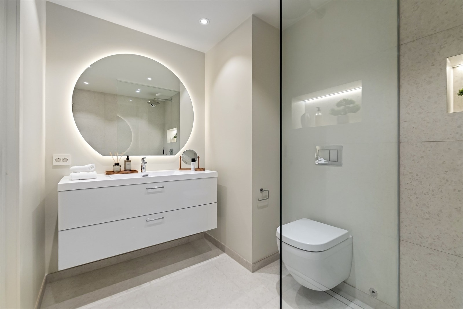 Moderne baderom fra 2025 med flislagt gulv, behagelig gulvvarme, downlights og malte veggflater kombinert med fliser Galleribilde