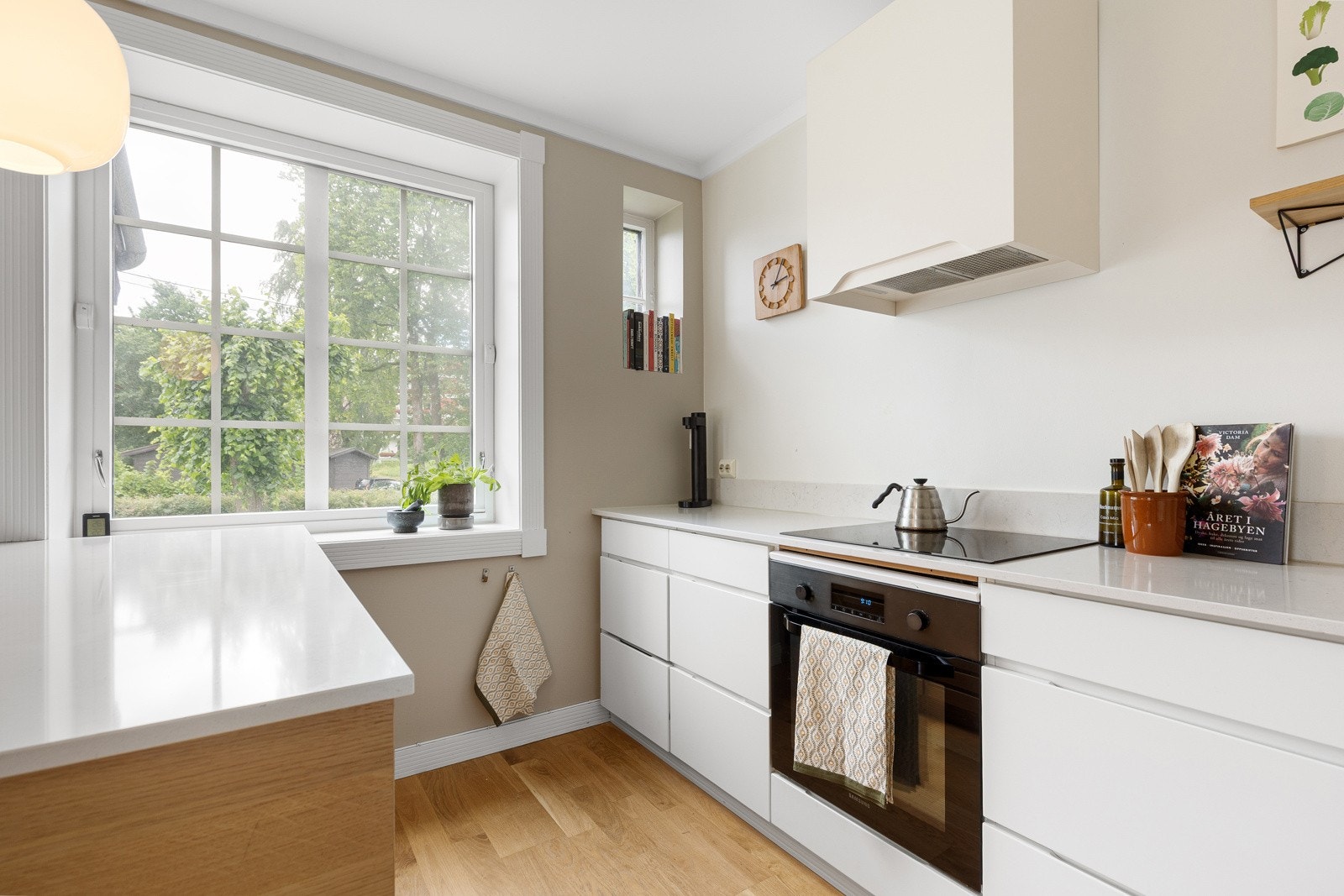 Kjøkkenet er utstyrt med kjøleskap, oppvaskmaskin, platetopp, vinskap og stekeovn Galleribilde