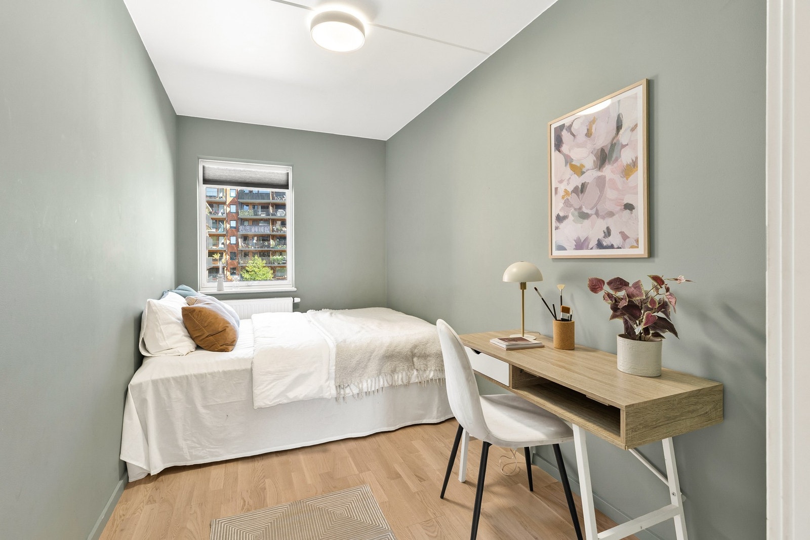 Boligens andre soverom er malt i en dus grønn farge som gir en harmonisk atmosfære. Galleribilde