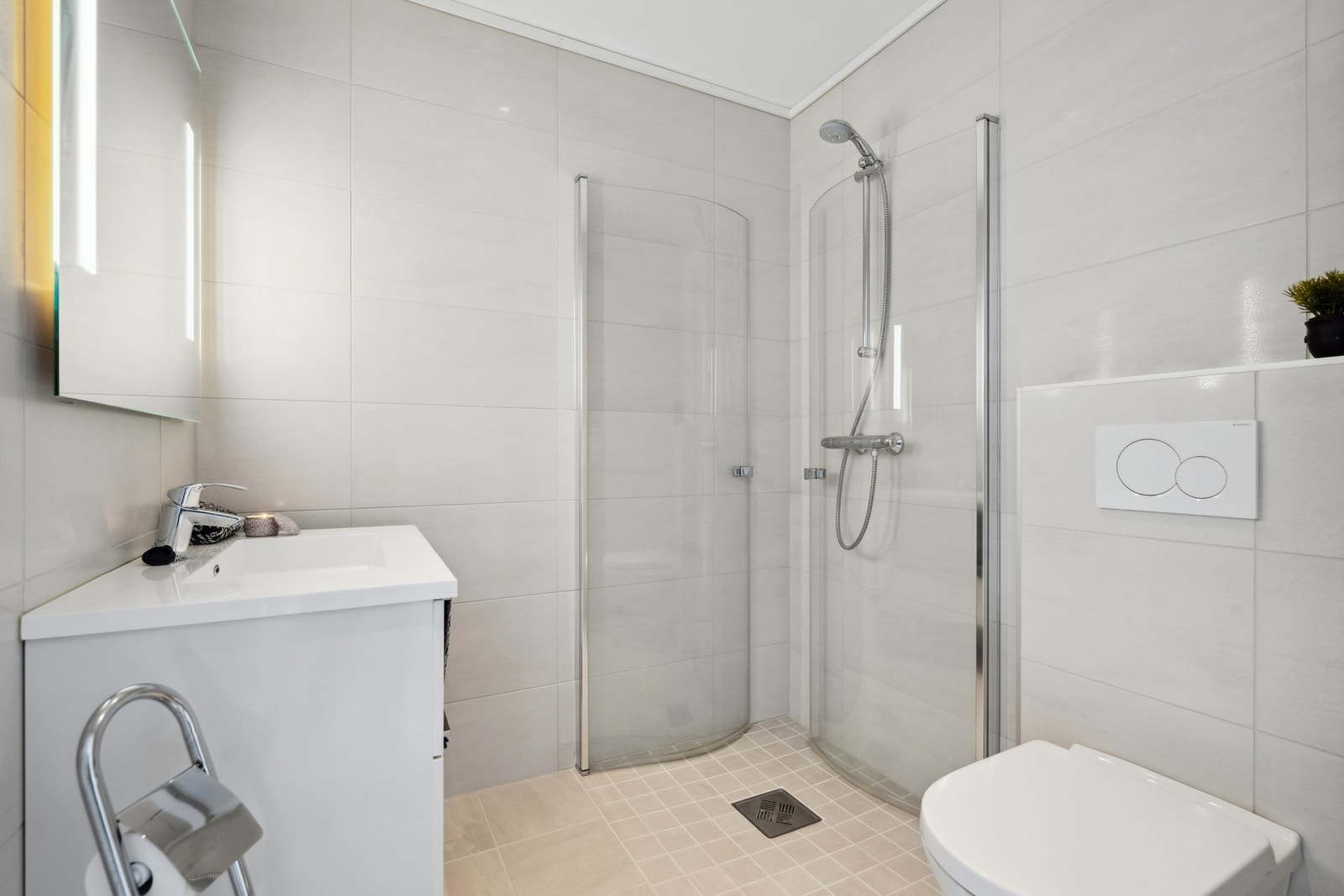 Flislagt bad i 1.etasje, innredet med heldekkende servant, toalett og dusjhjørne Galleribilde