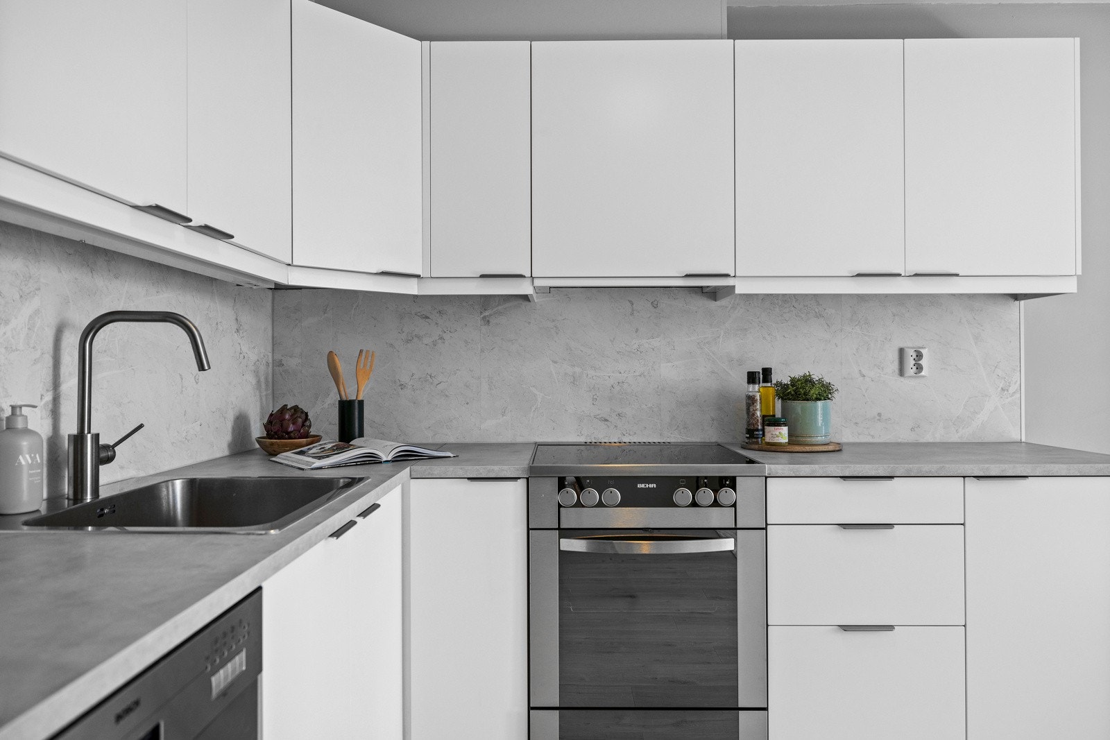 - Kjøkken med benkeplate i laminat, kjøkkenplater på vegg over kjøkkenbenk (2024). Opplegg for frittstående kjøl-frys, komfyr og oppvaskmaskin - Galleribilde