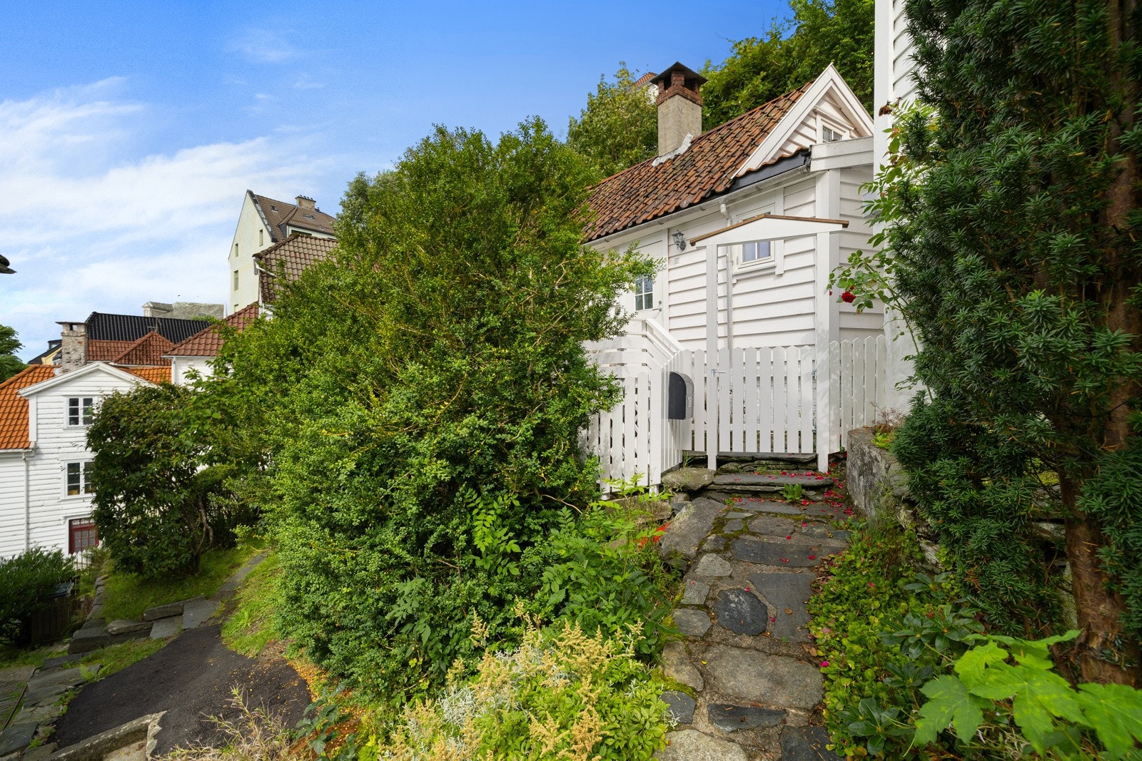 Eiendommen har et åpent og luftig areal i front av huset med skjermet og fint inngangsparti Galleribilde