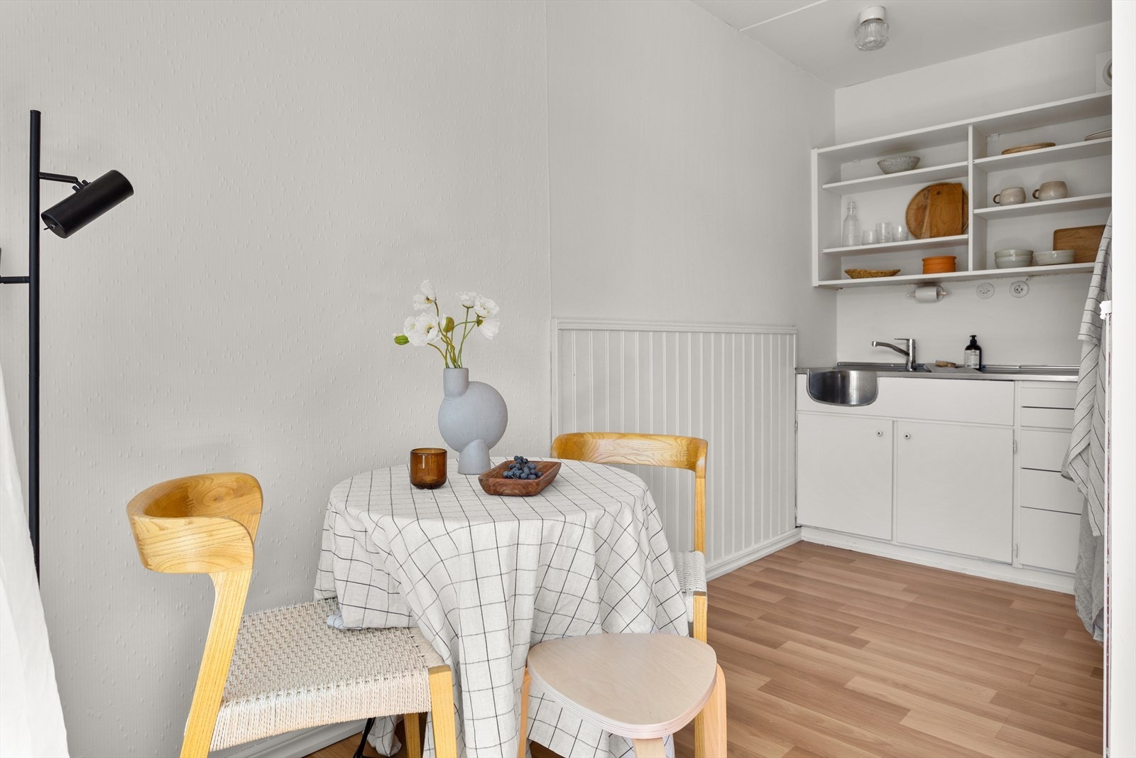 Hvite, slette fronter og heldekkende benkebeslag med et-greps blandebatteri fra 2025. Galleribilde