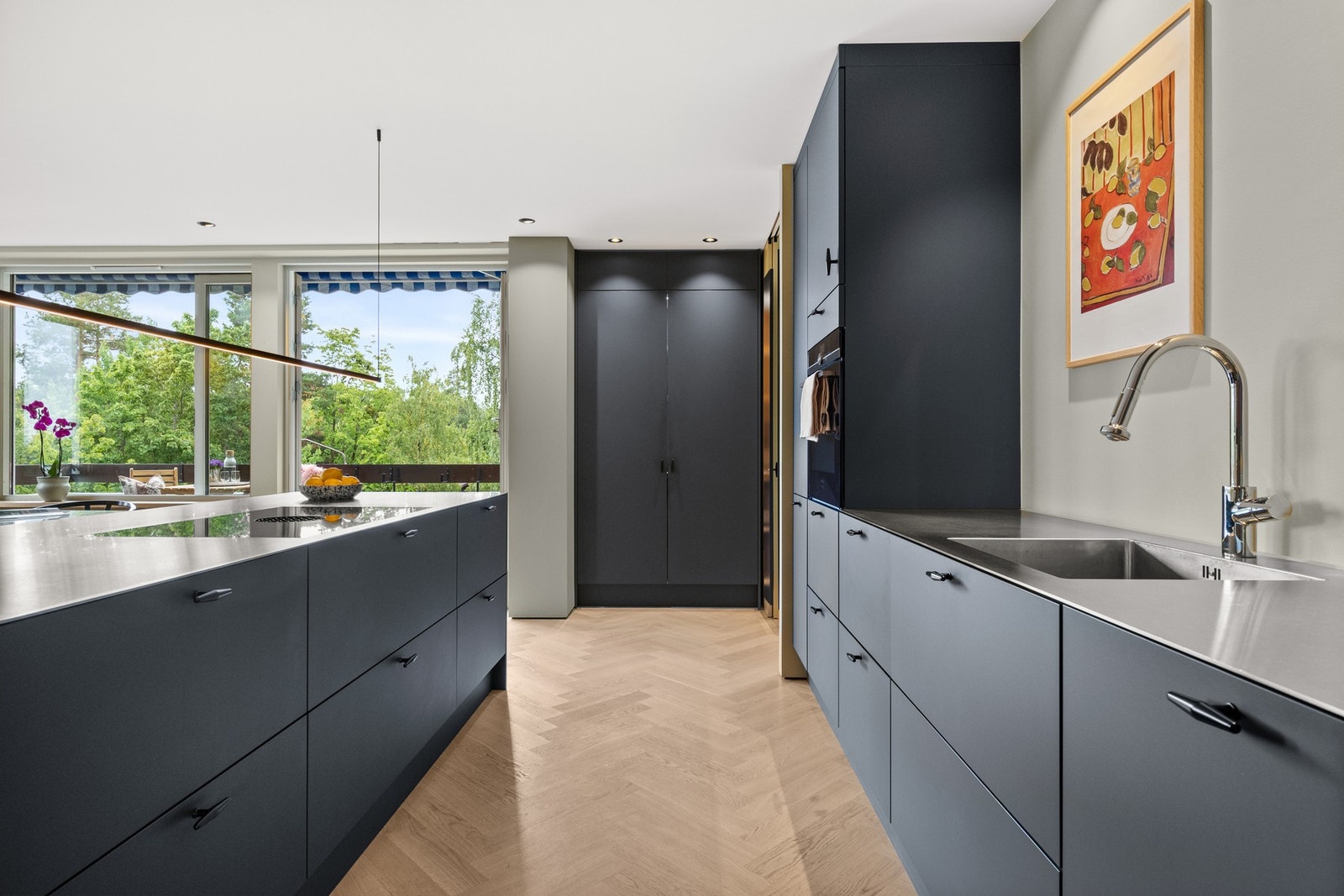 Kjøkkenet har store vindusflater som gir rikelig med naturlig lys og en luftig atmosfære. Galleribilde