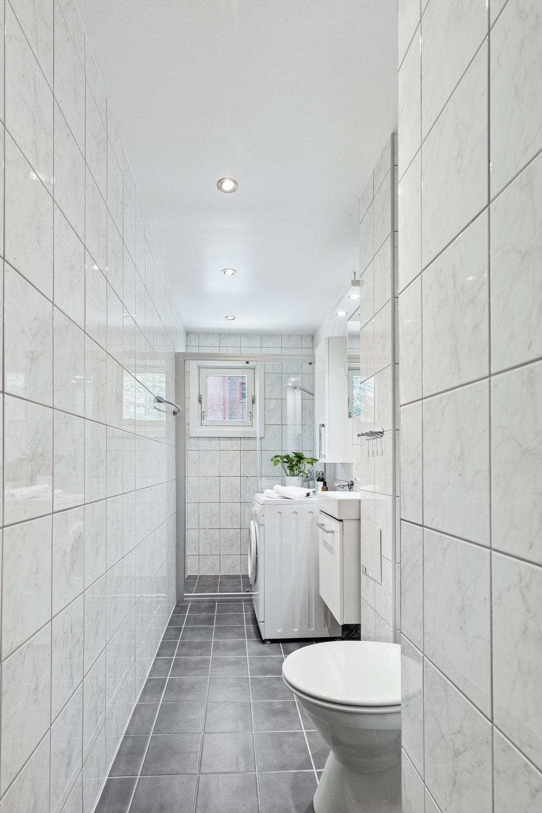 Flislagt bad med opplegg for vaskemaskin Galleribilde