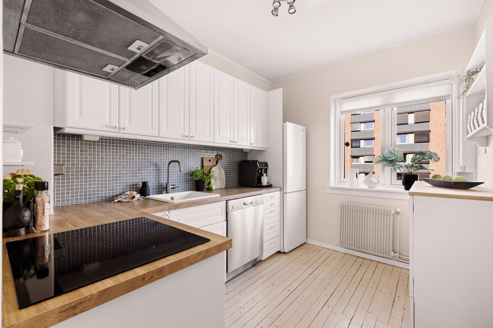 Kjøkkenet fra 2020 har heltre benkeplate og klassiske profilerte fronter. Galleribilde