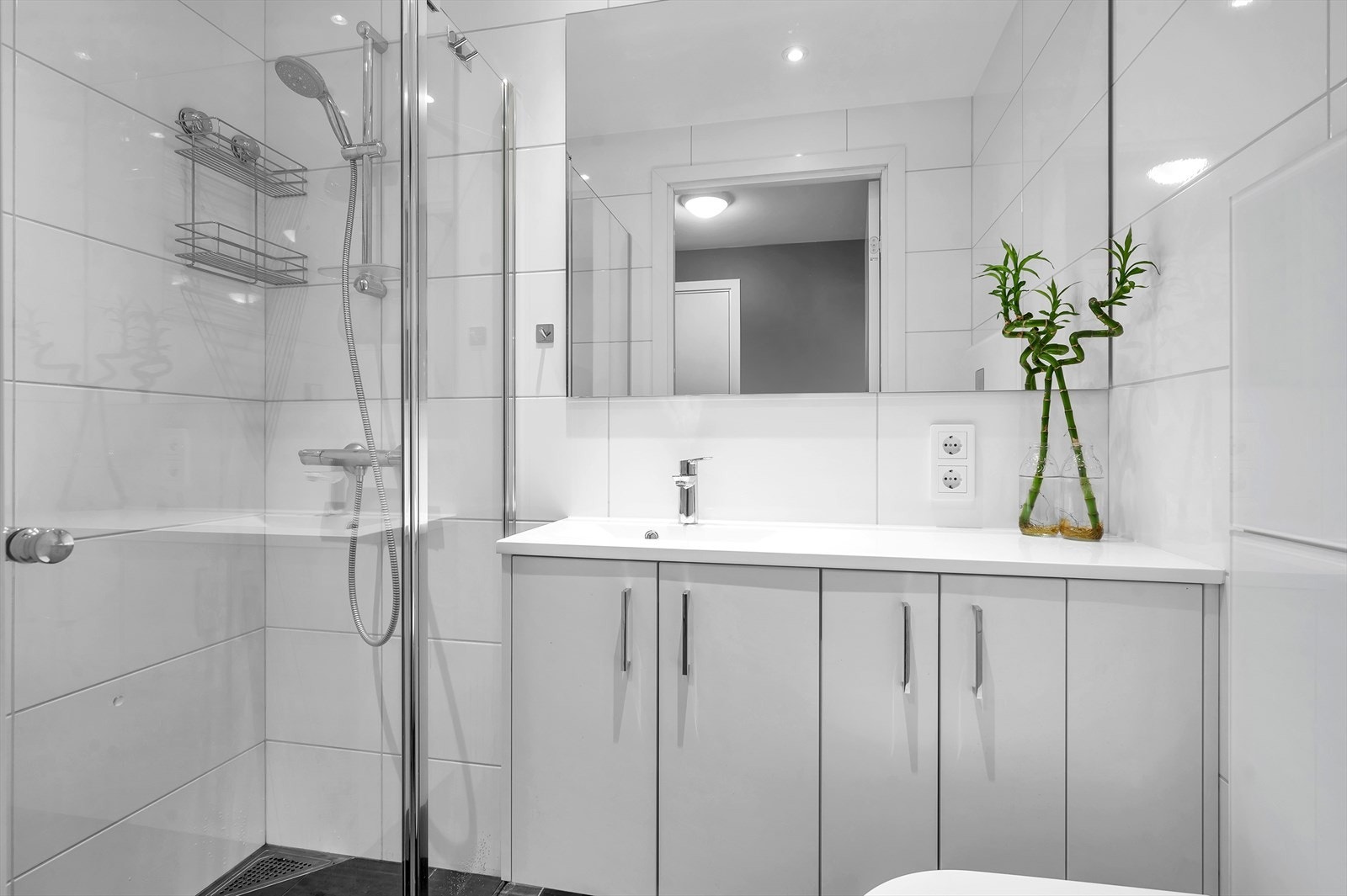 Bad 2 med dusjhjørne, vegghengt toalett og servant med underskap. Galleribilde