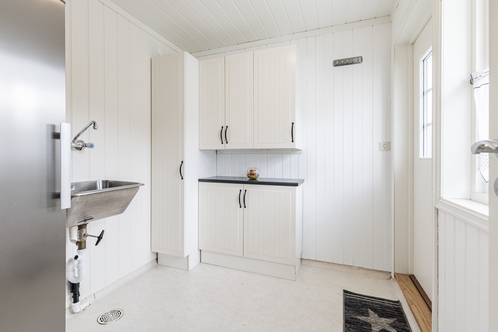 Vaskerommet har egen praktisk utgang til inngangssiden. I rommet er det utslagsvask og opplegg for vaskemaskin. Galleribilde