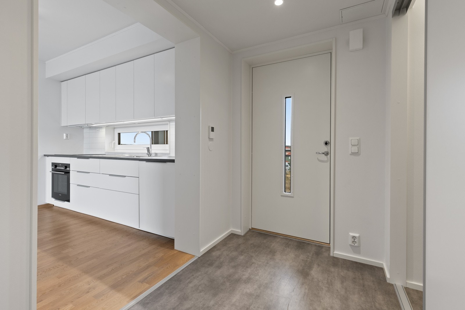 Tiltalende entre/gang med slitesterkt belegg på gulv og lysmalte slette veggflater som gir et godt førsteinntrykk av leiligheten. Galleribilde