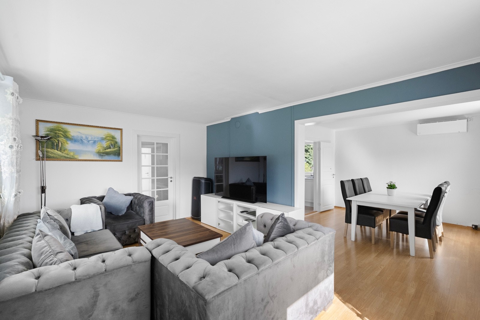 En lys og romslig stue med store innredningsmuligheter og naturlig plass til både sofagruppe og spisestue Galleribilde