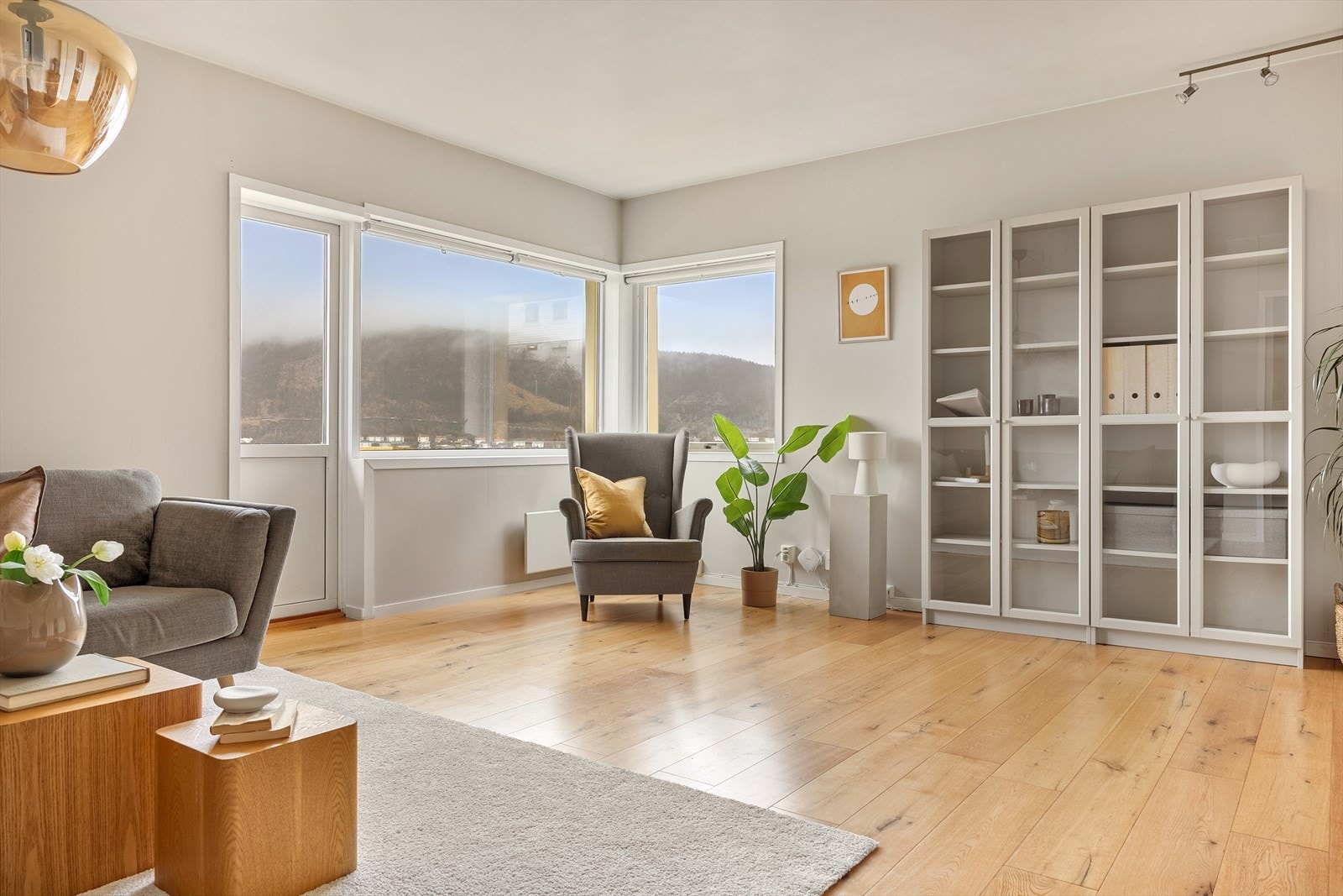 Vi beveger oss inn i en romslig stue, hvor store vindusflater sørger for mye lysinnslipp og flott utsikt Galleribilde