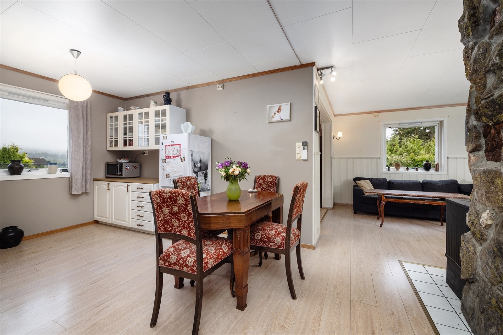 Delvis åpen stue-/kjøkkenløsning med plass til spisebord og stoler. Galleribilde