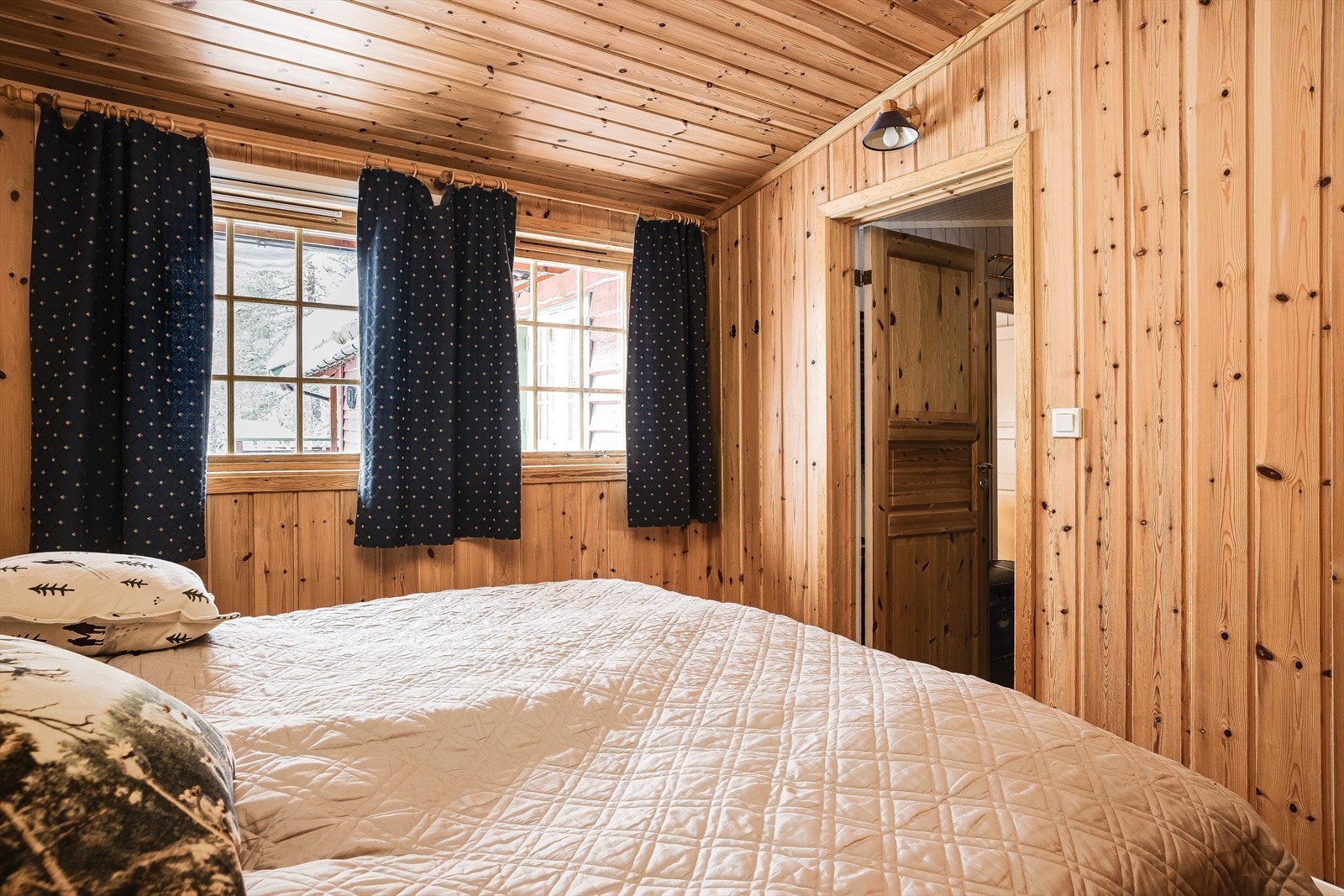 Soverommet har tregulv, overflater med trepanel og to vindusflater. Galleribilde