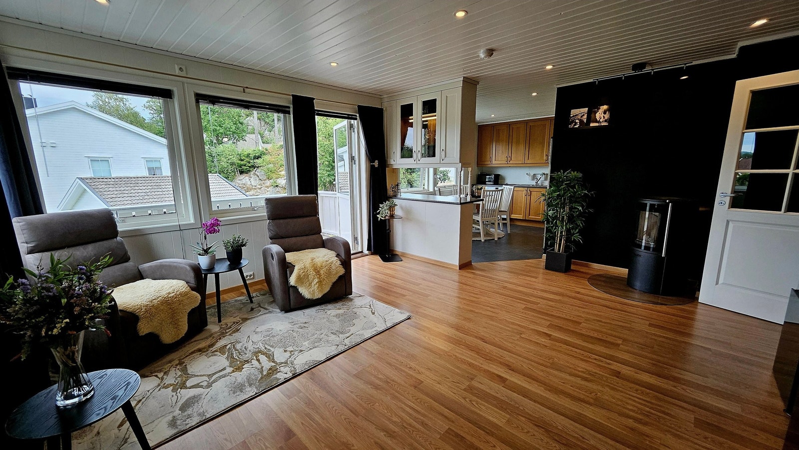 Åpen stue - og kjøkkenløsning, elegant adskilt med en stilrent benk Galleribilde