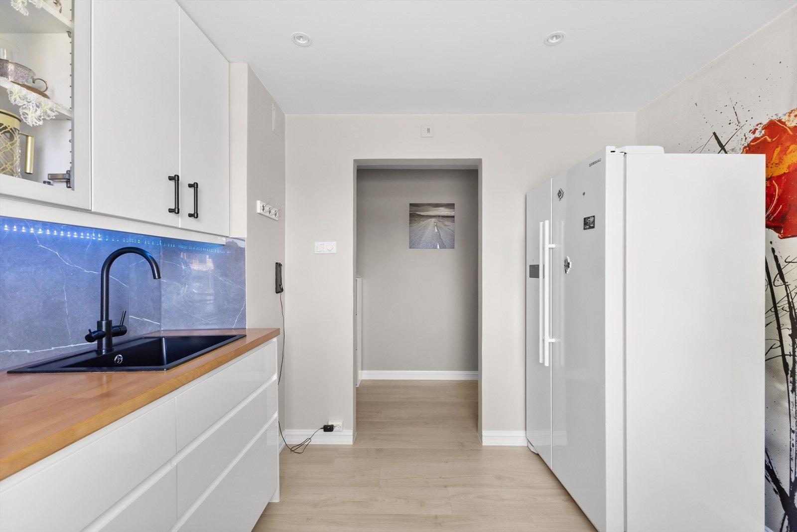 Rommet har lyst laminatgulv med elektrisk gulvvarme og downlights i taket. Galleribilde